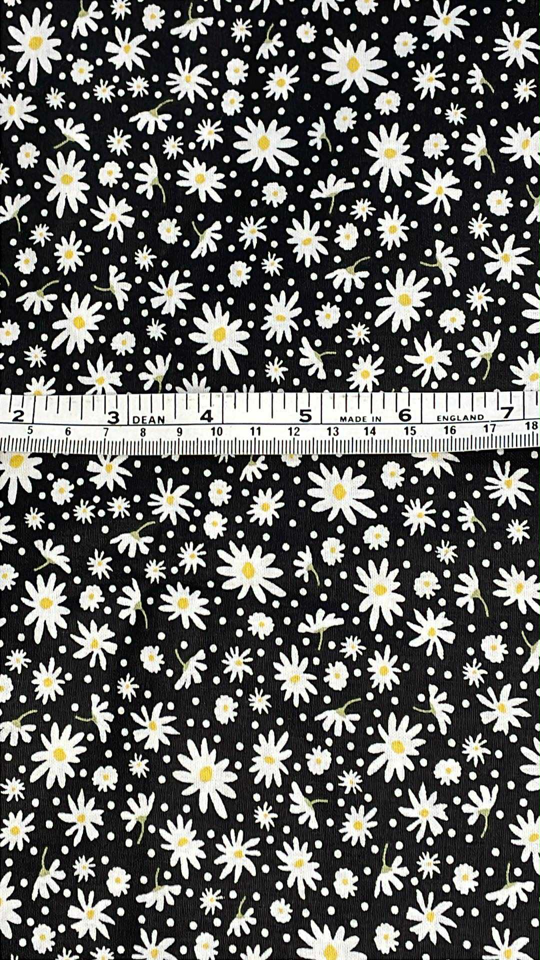 white daisys with yellow centers on black