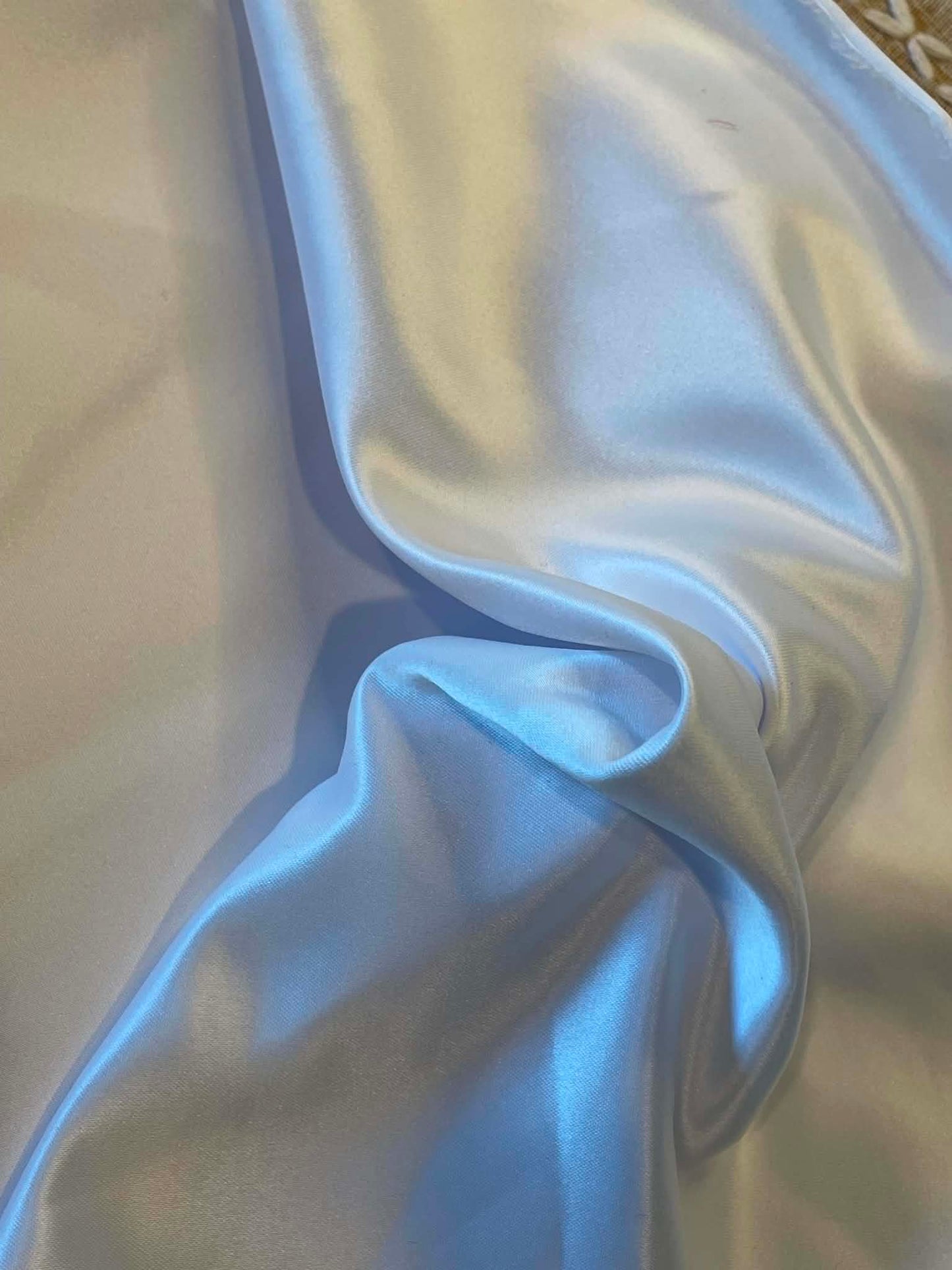 White Satin, crepe back. Sold by the yard.