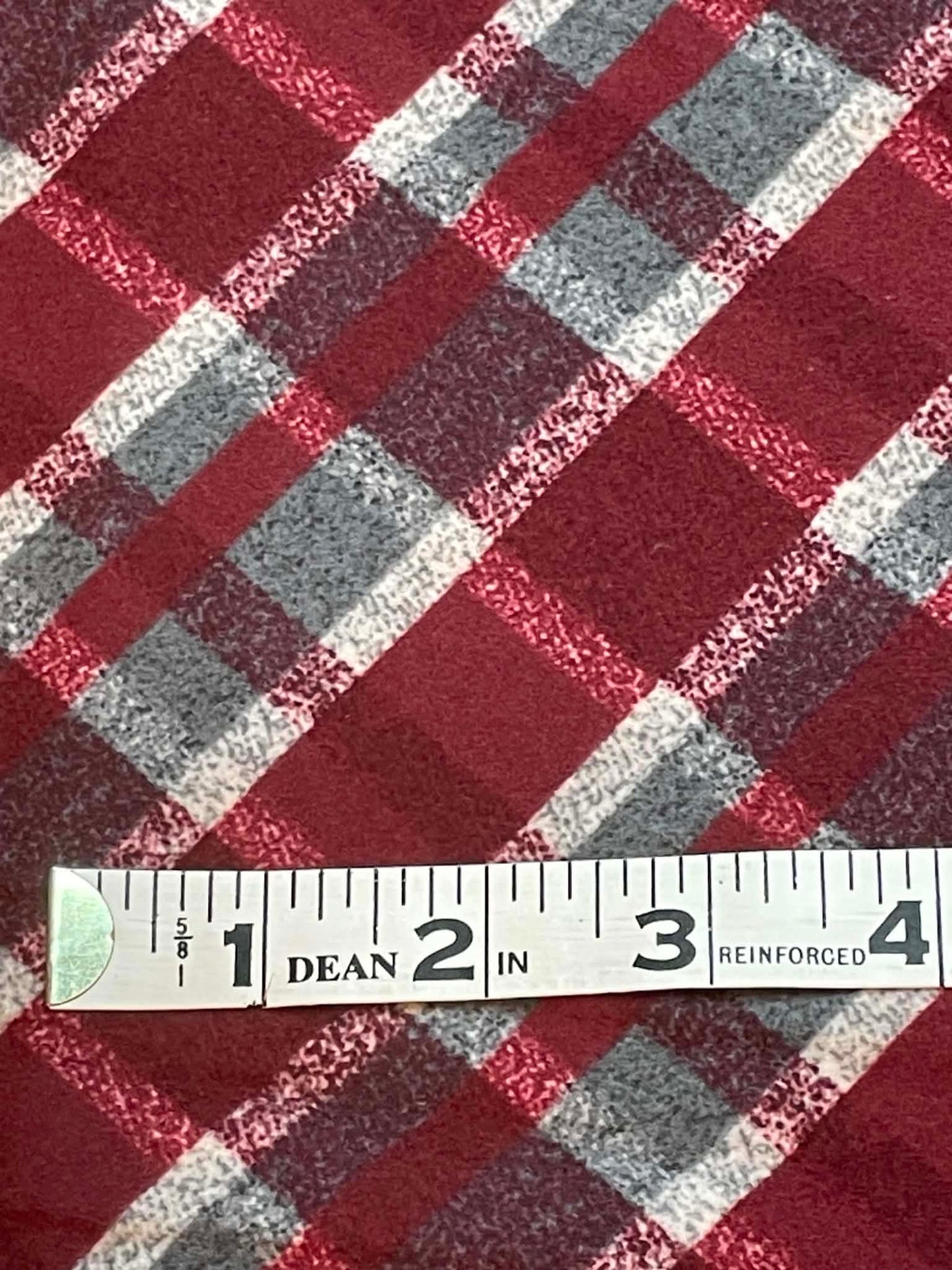 Red, gray and white plaid flannel. Sold by the yard.
