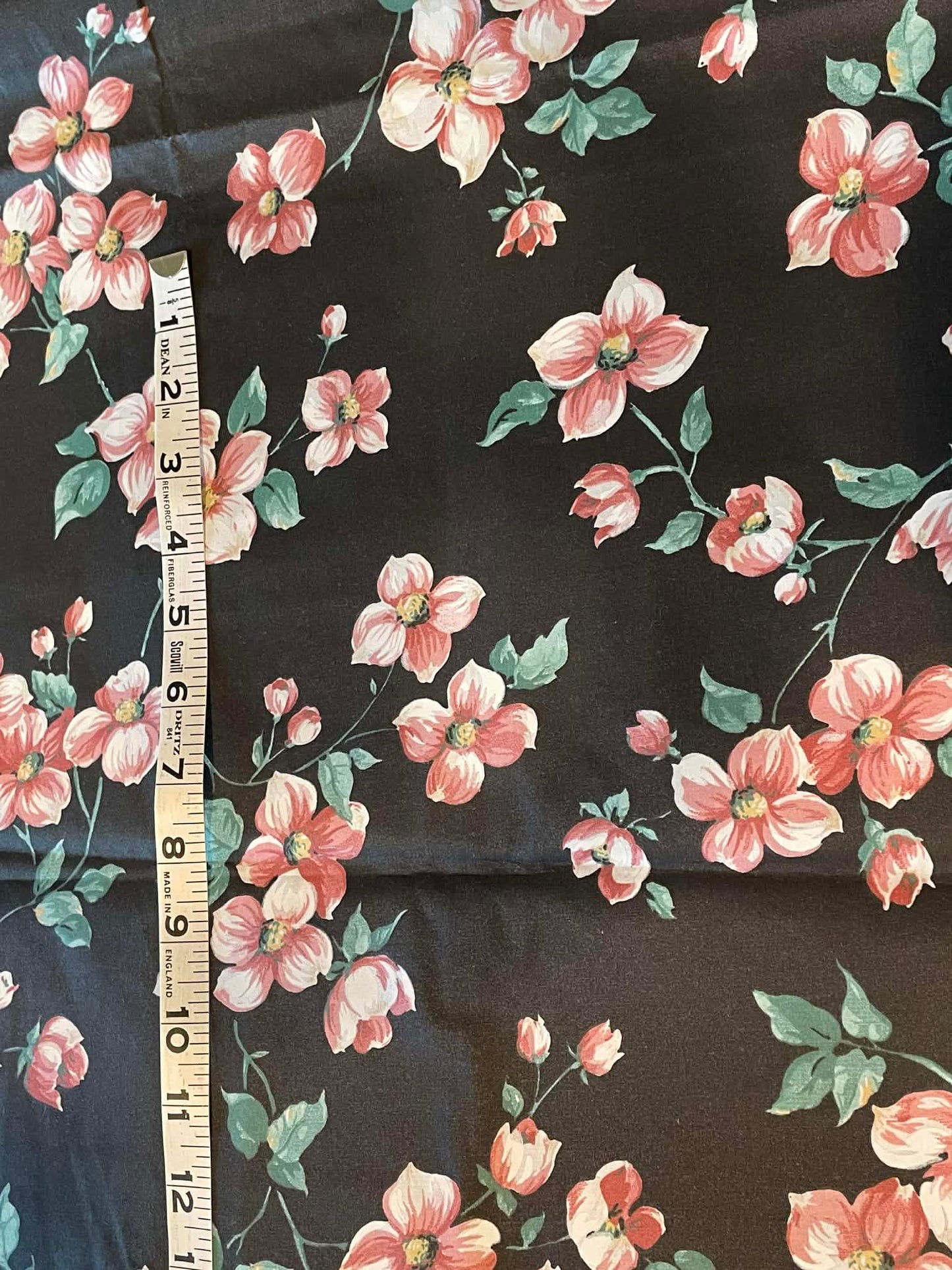 45" wide. Pink flower, green leaves on black background - Sold by the 1/2 yard.