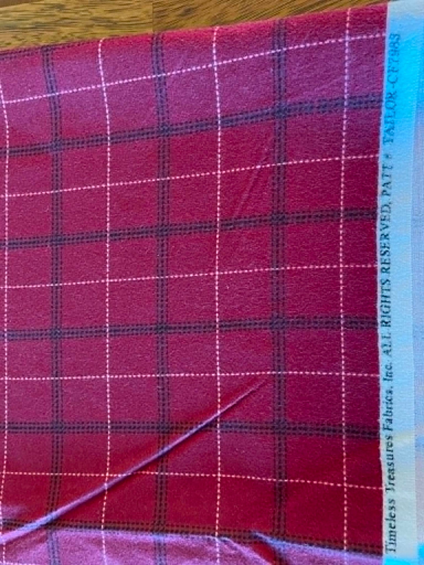 Flannel. Red with black and white. Sold by the yard