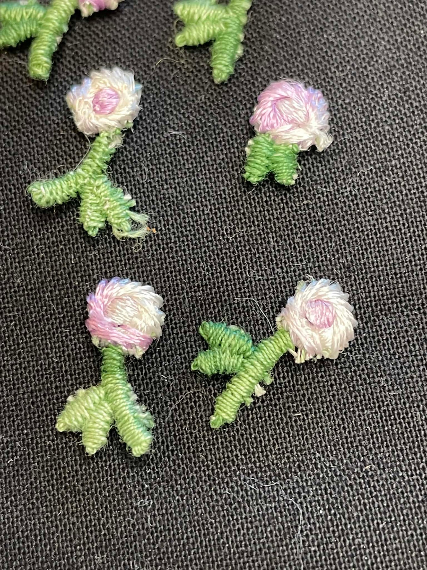 13 tiny embroidered flowers applique sold as a group.
