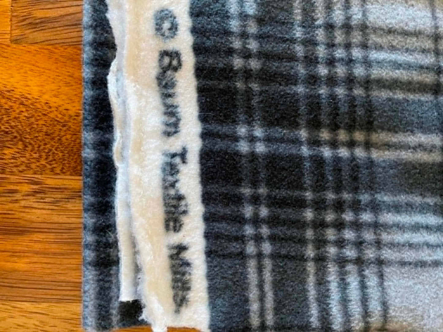 REMNANT ** Black and gray plaid fleece.