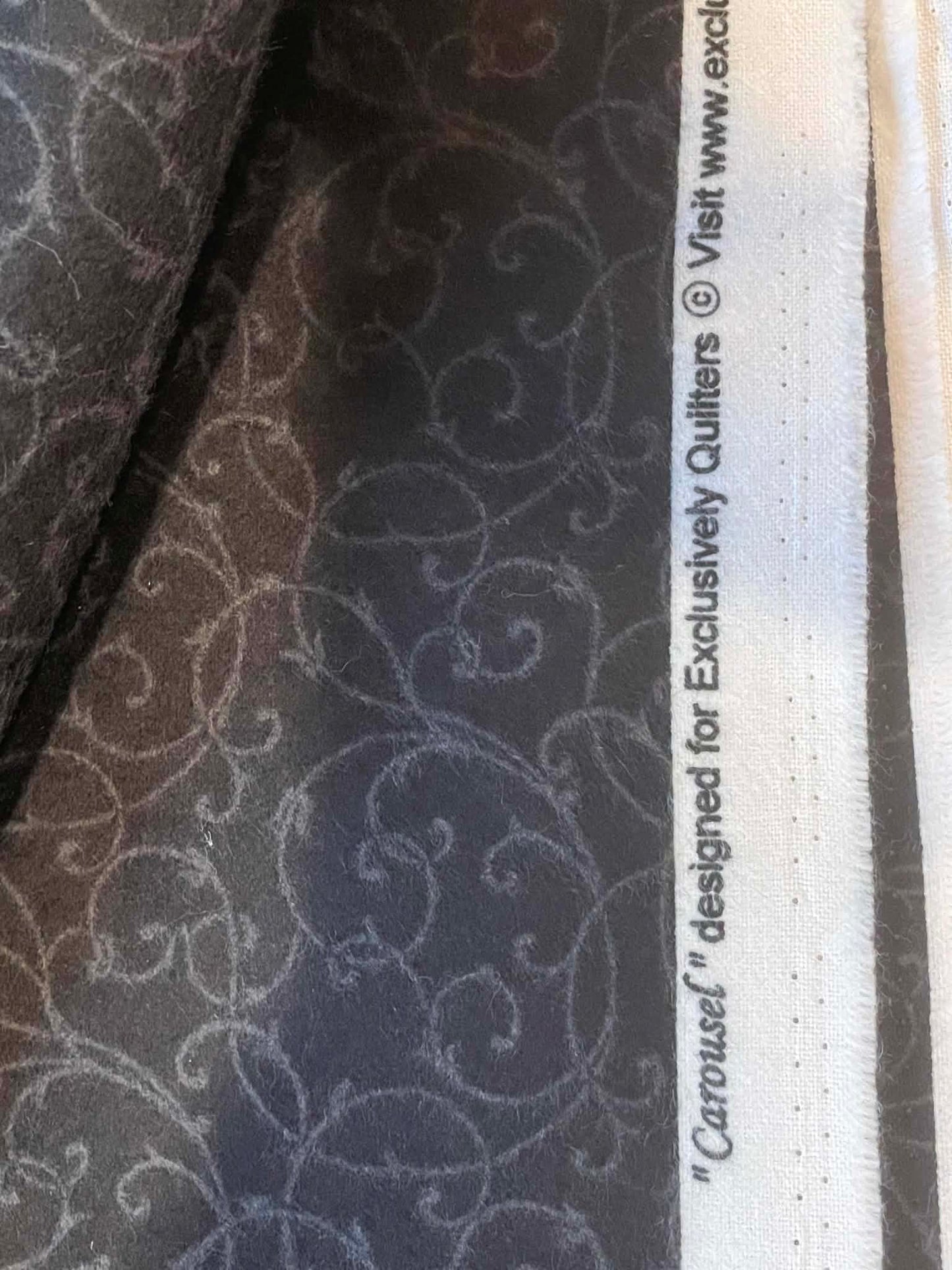 Flannel. "Carousel" Black with gray swirls. Sold by the half yard.