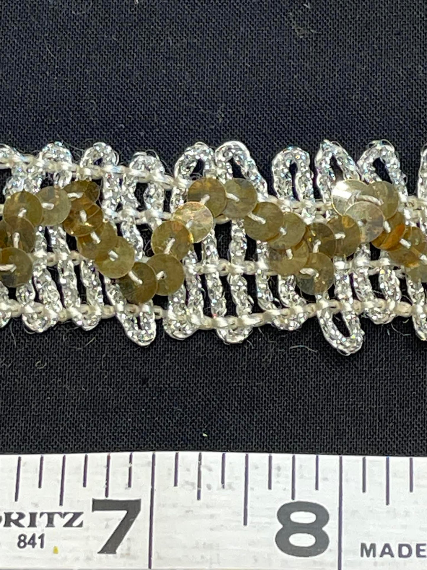 1 1/4" wide stretch sequin trim. Sold by the half yard.