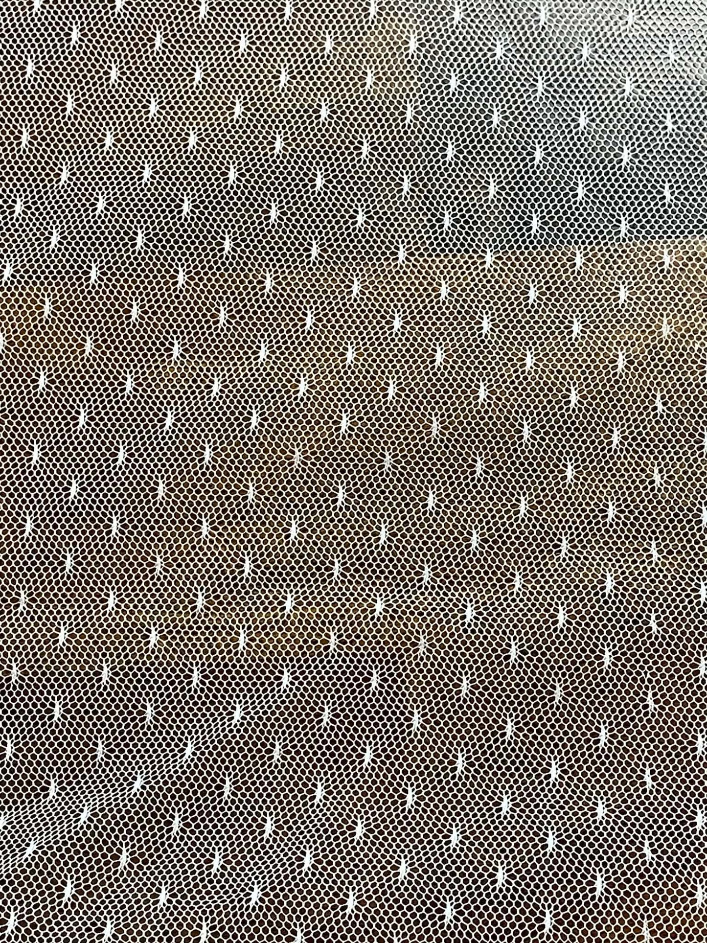White mesh with pattern white specks. Sold by the yard.