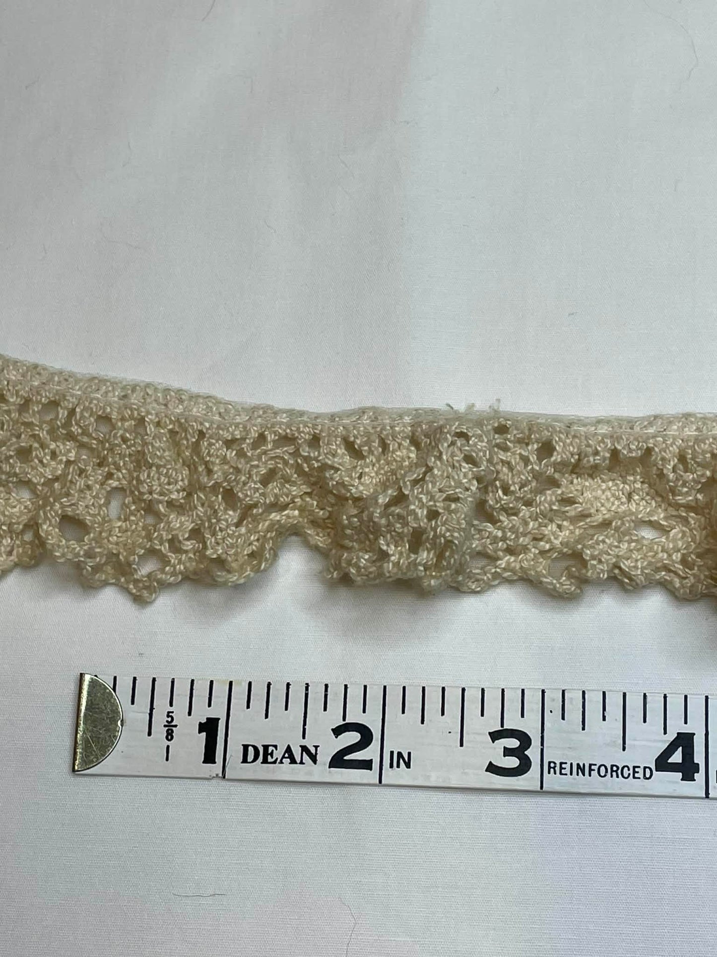 1 1/2" wide. Crochet lace trim. Sold by the yard.