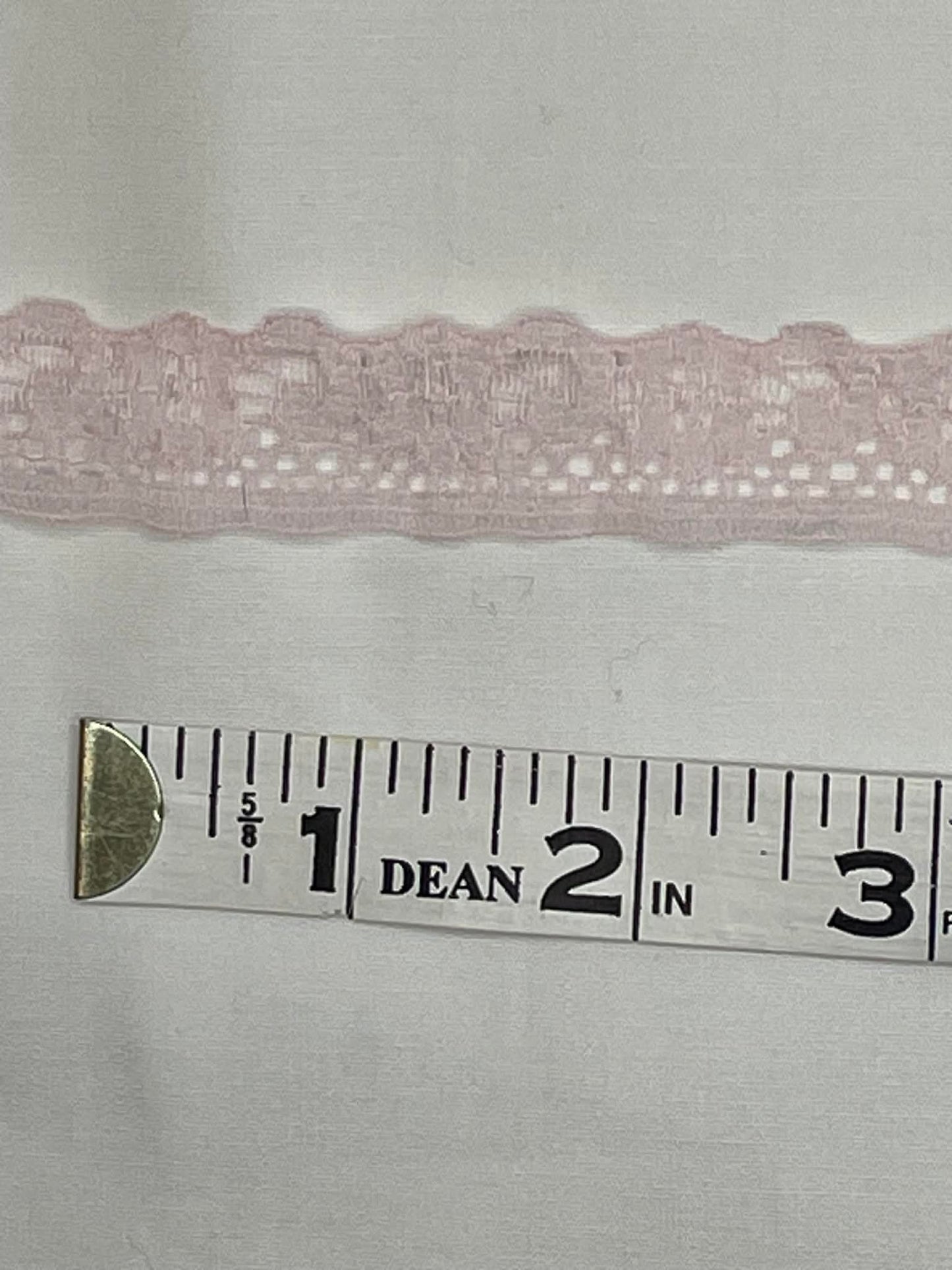 3/4" wide light pink lace Trim. Sold by the yard.