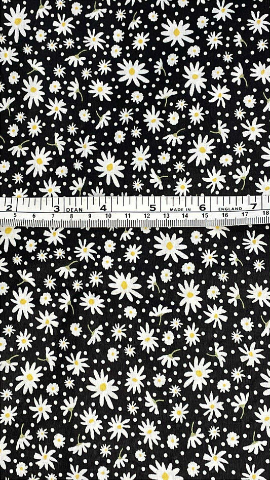white daisys with yellow centers on black