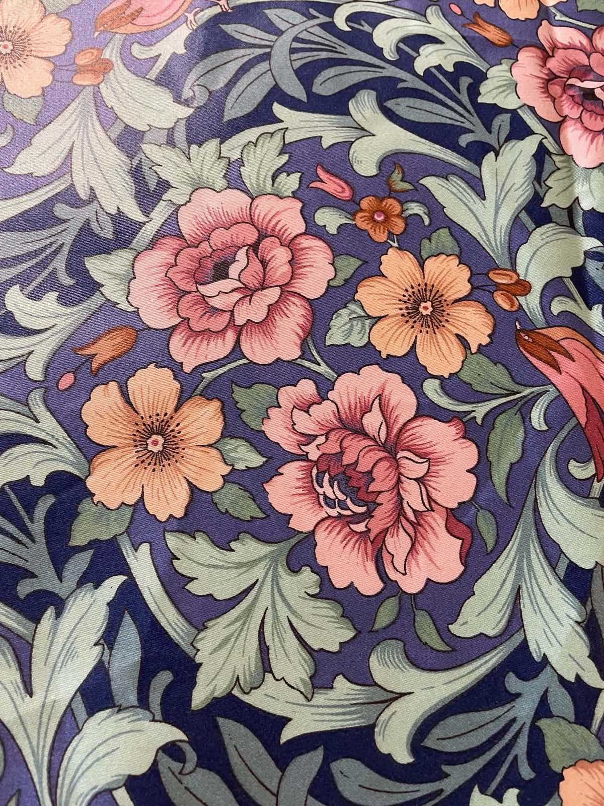Interior upholstery fabric.  Peach and pink floral with a nice sheen.  Sold by the yard.
