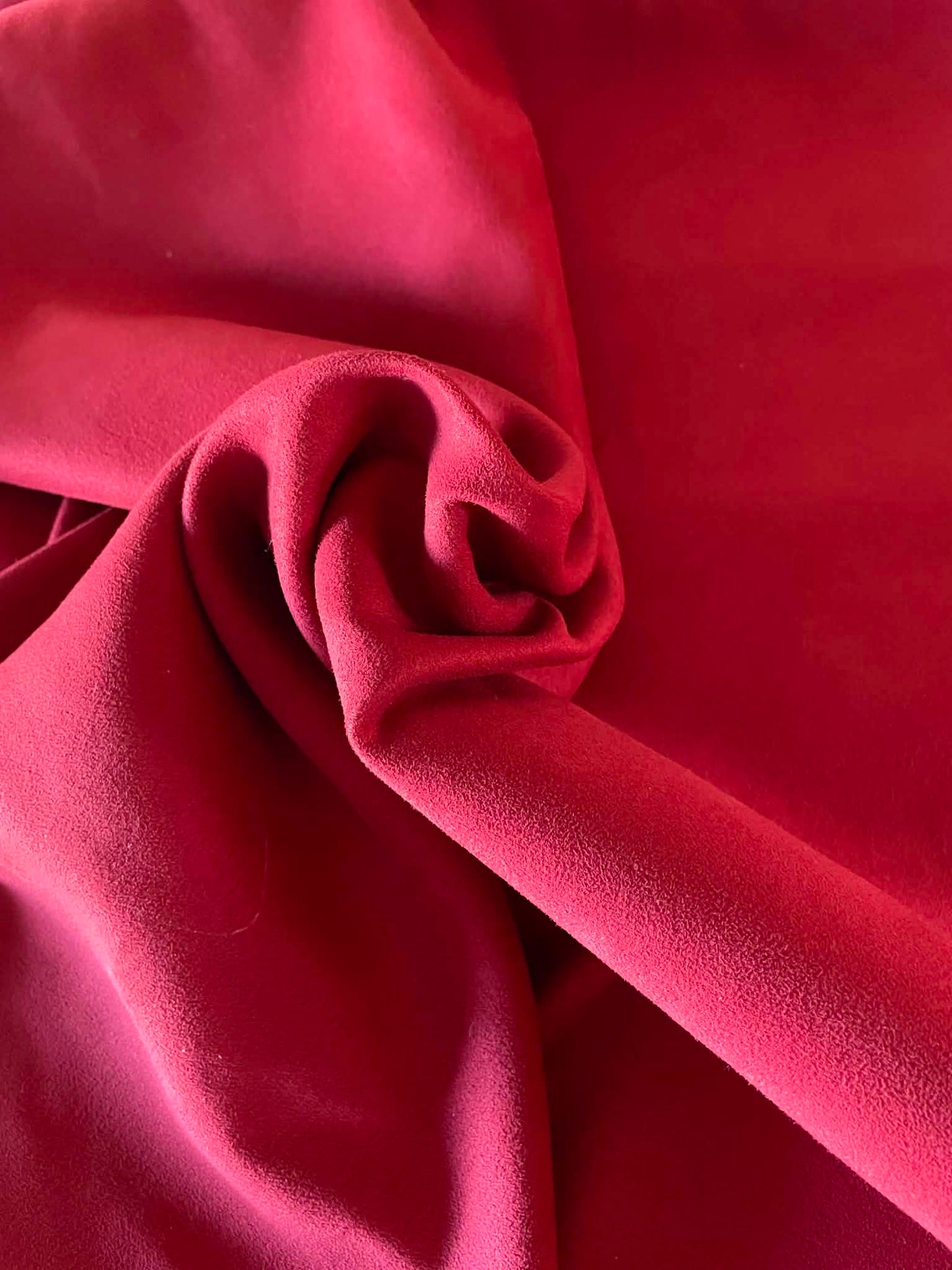 Burgundy color faux suede.  Sold by the yard.