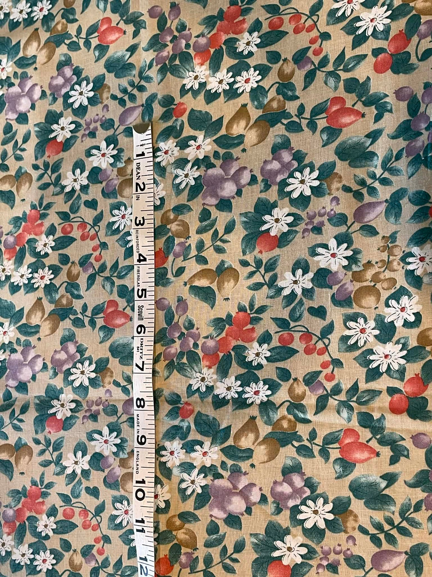 Purple, orange and tan fruits, white flowers on tan background - Sold by the 1/2 yard.