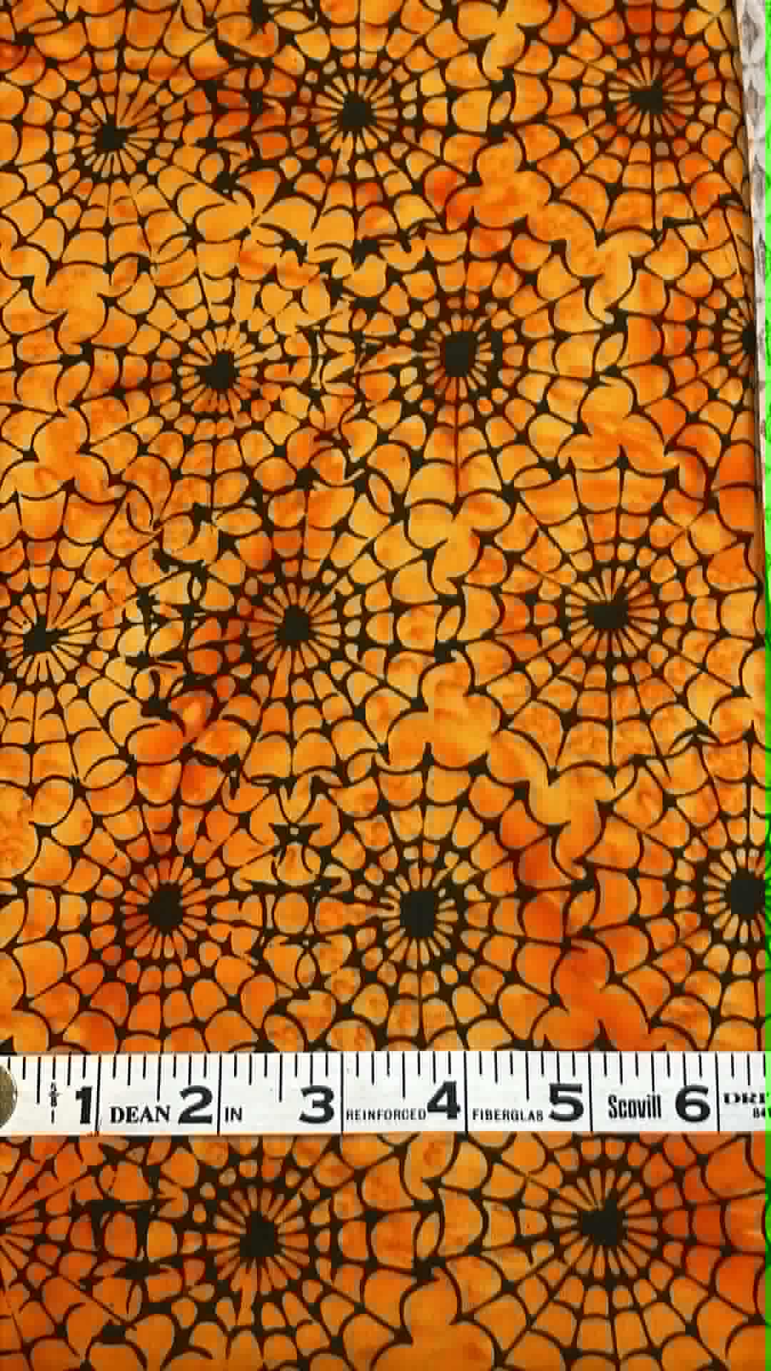 Island Batik - Spiders on Orange - Sold by the half yard.
