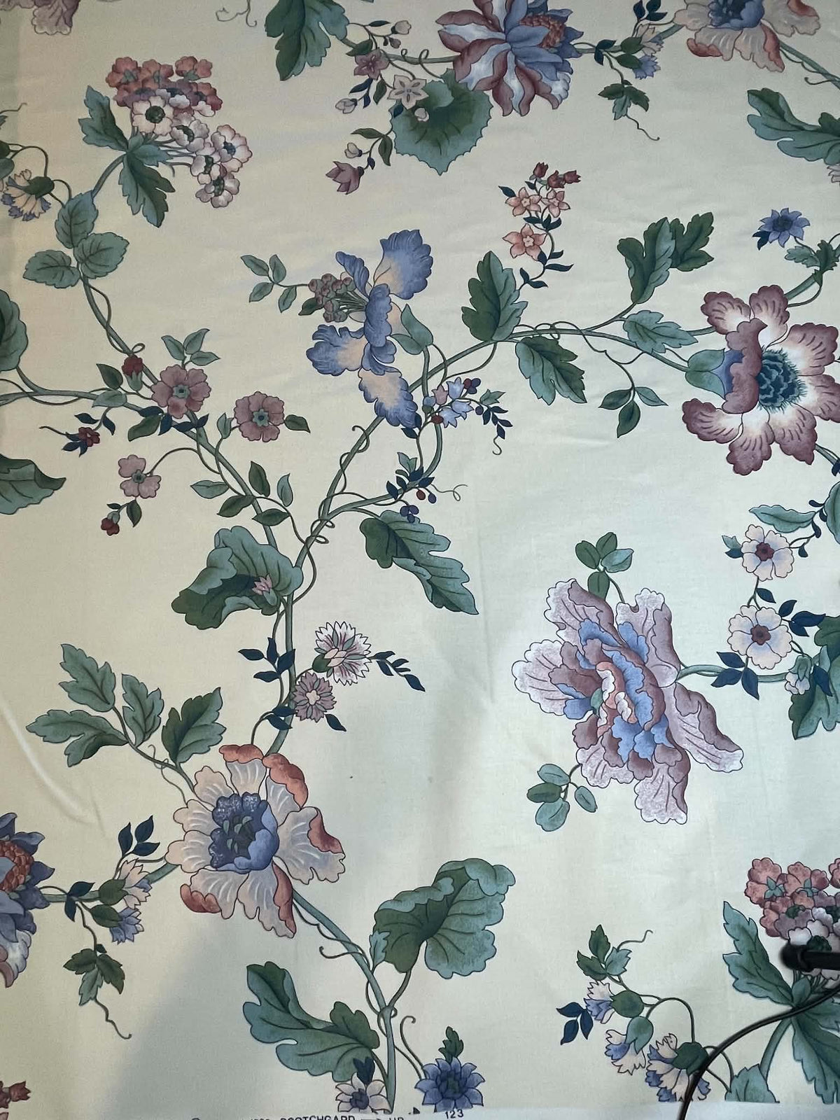 Blue, green and peach floral on white.  Upholstery fabric.  Sold by the yard.