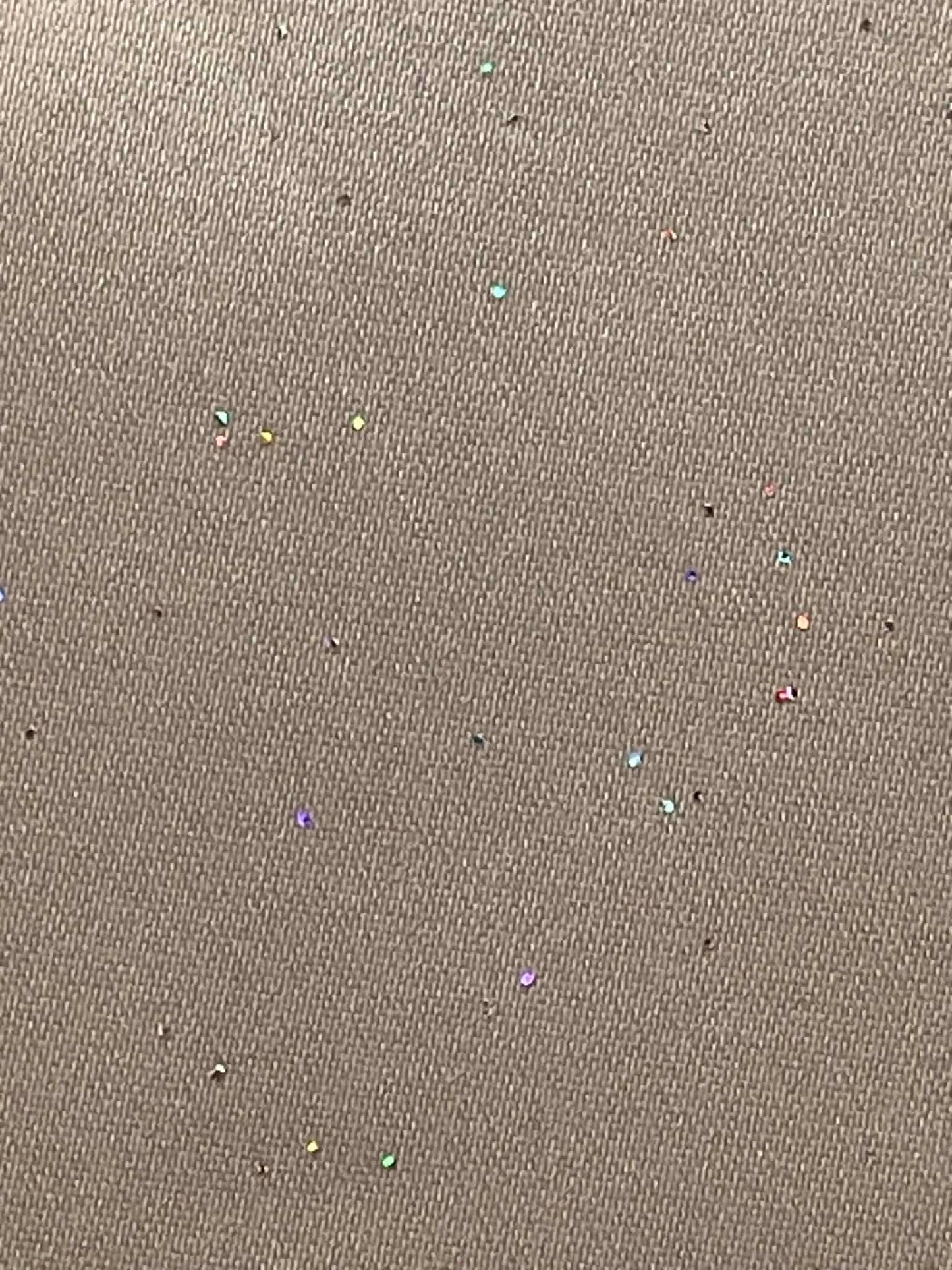 Gray satin with multi-colored sparkles throughout.  Sold by the yard.