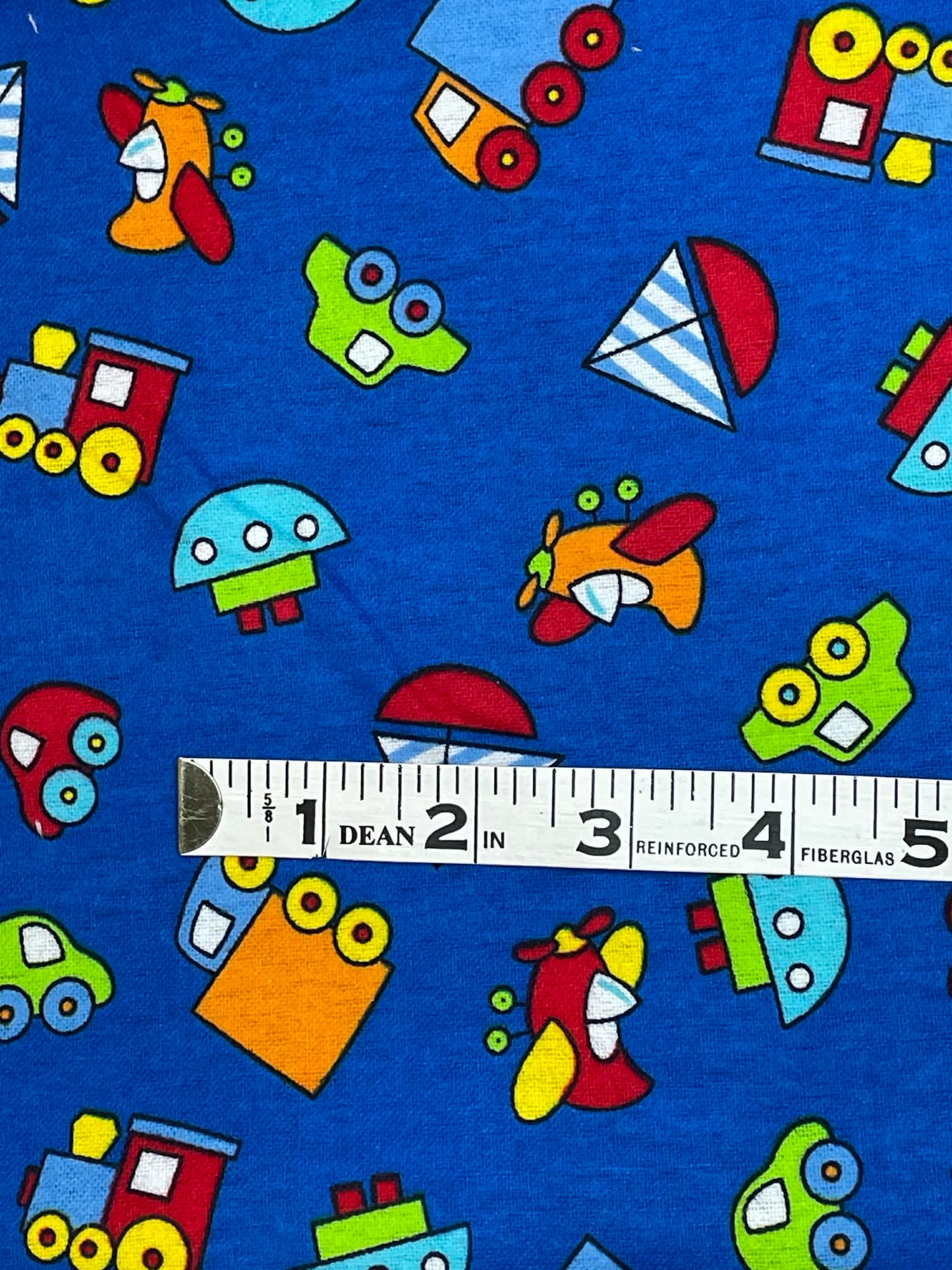 Flannel print.  Toys on navy blue background.  Sold by the yard.