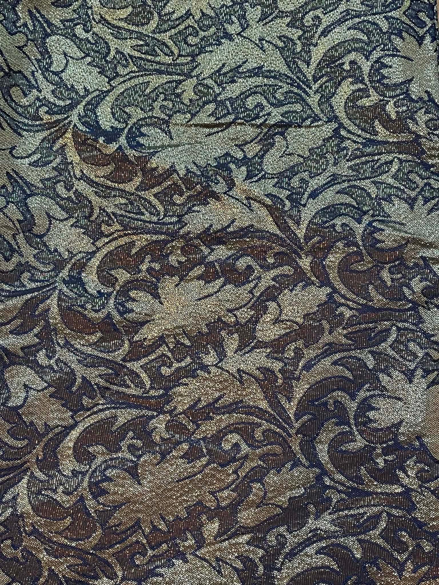 Black and metallic gold brocade.  Sold by the yard.