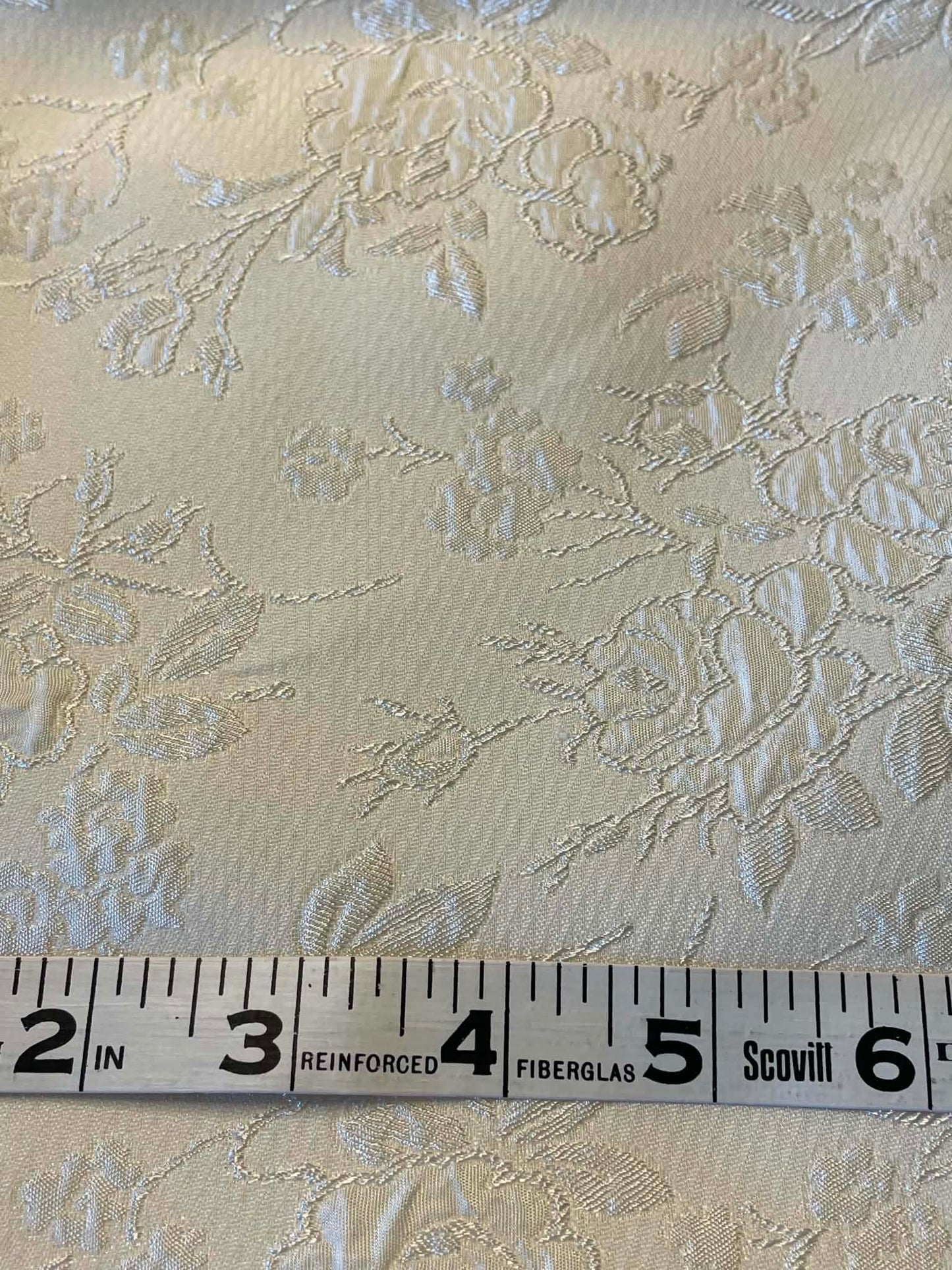 Cream colored satin jacquard.  Sold by the yard.