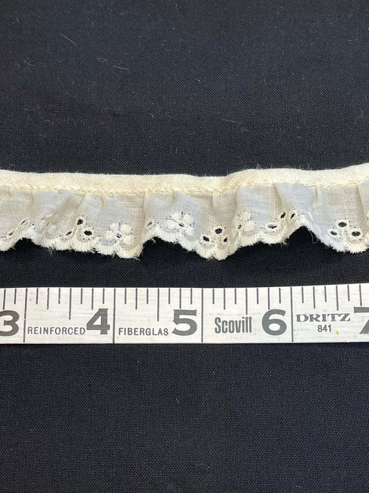 1" wide ruffled eyelet lace.  Sold by the yard.