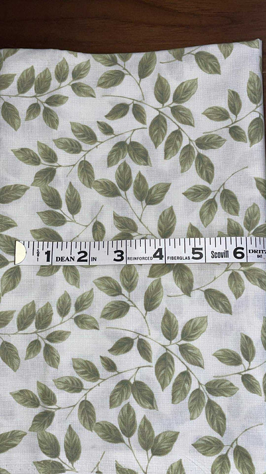 Green leaves on off white background