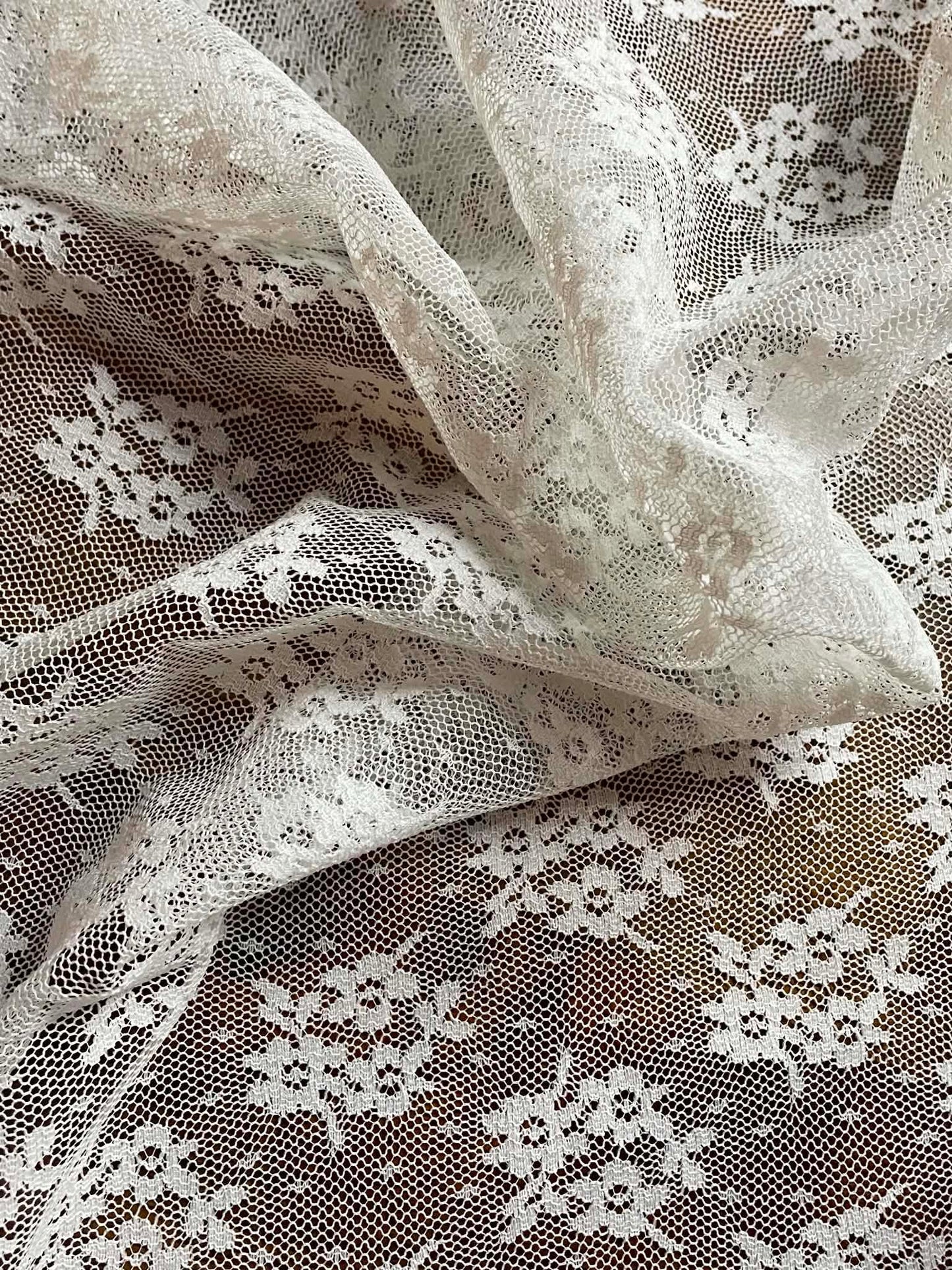 White floral all over lace.  Sold by the half yard.