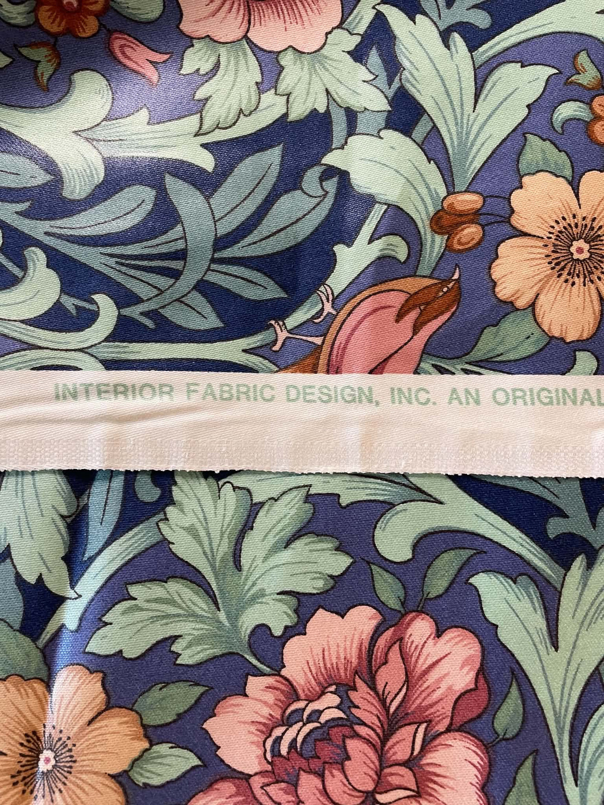 Interior upholstery fabric.  Peach and pink floral with a nice sheen.  Sold by the yard.