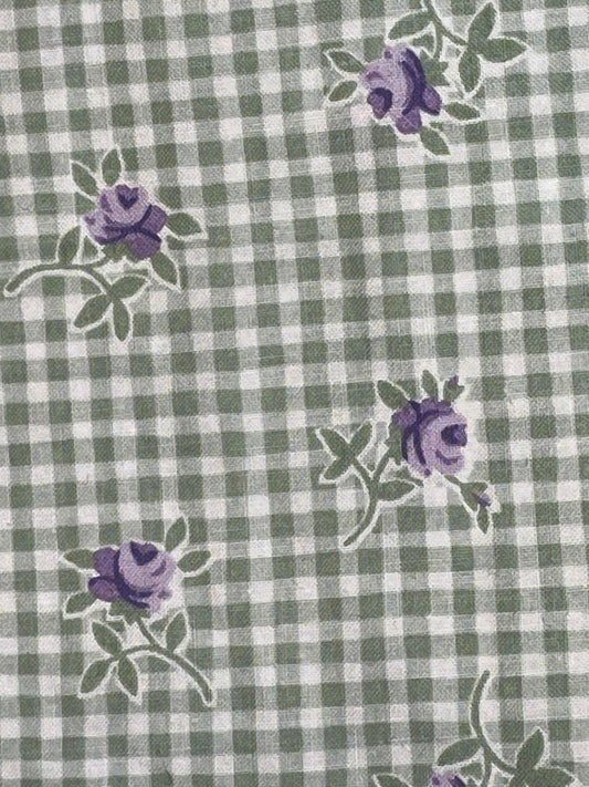 Purple flowers on green and white check background.  Sold by the half yard.