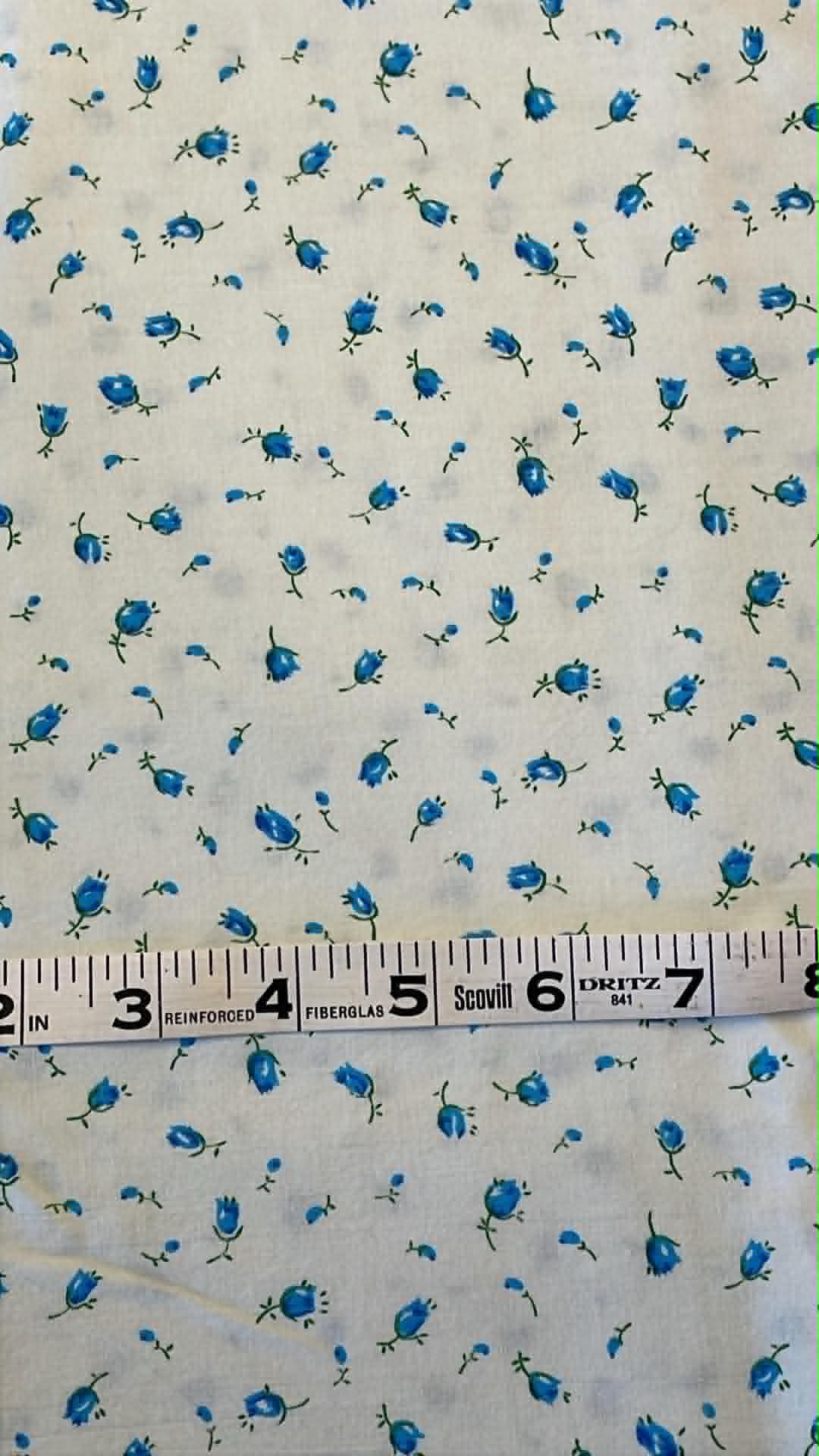 Ditsy floral.  Blue flowers on white.  Sold by the half yard.