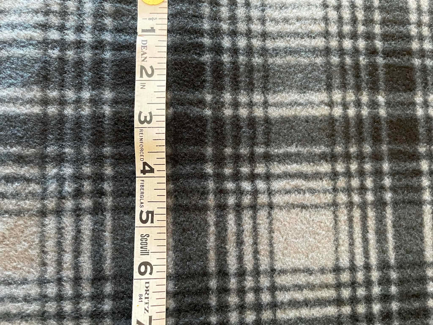 REMNANT ** Black and gray plaid fleece.