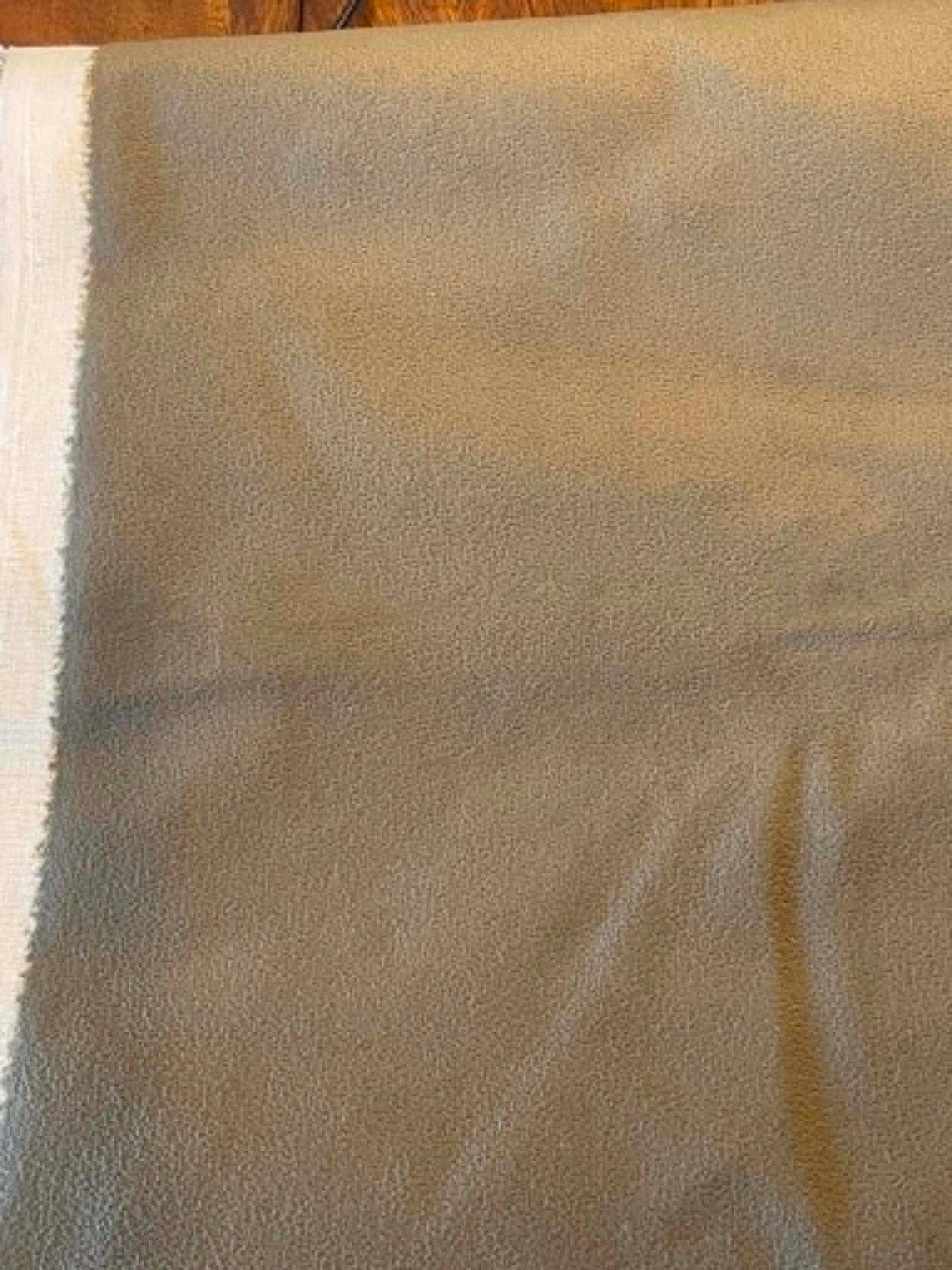Dark green, suede like upholstery fabric.  Sold by the yard.
