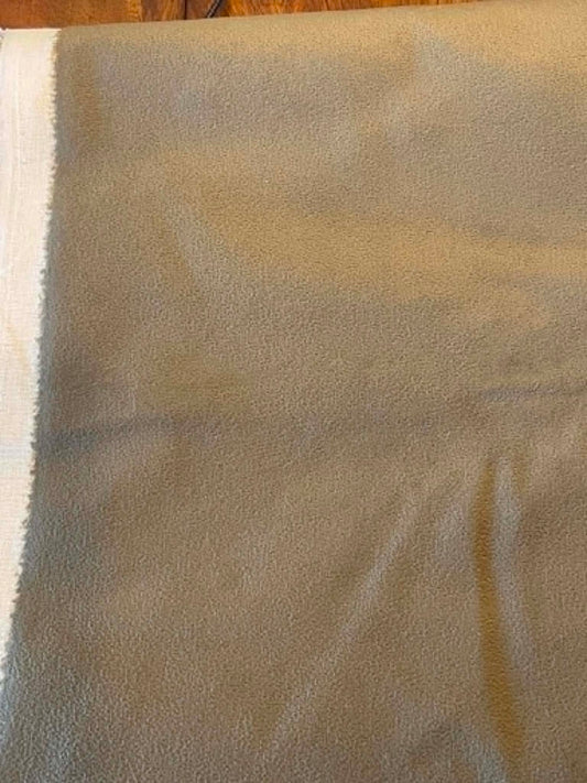 Dark green, suede like upholstery fabric.  Sold by the yard.