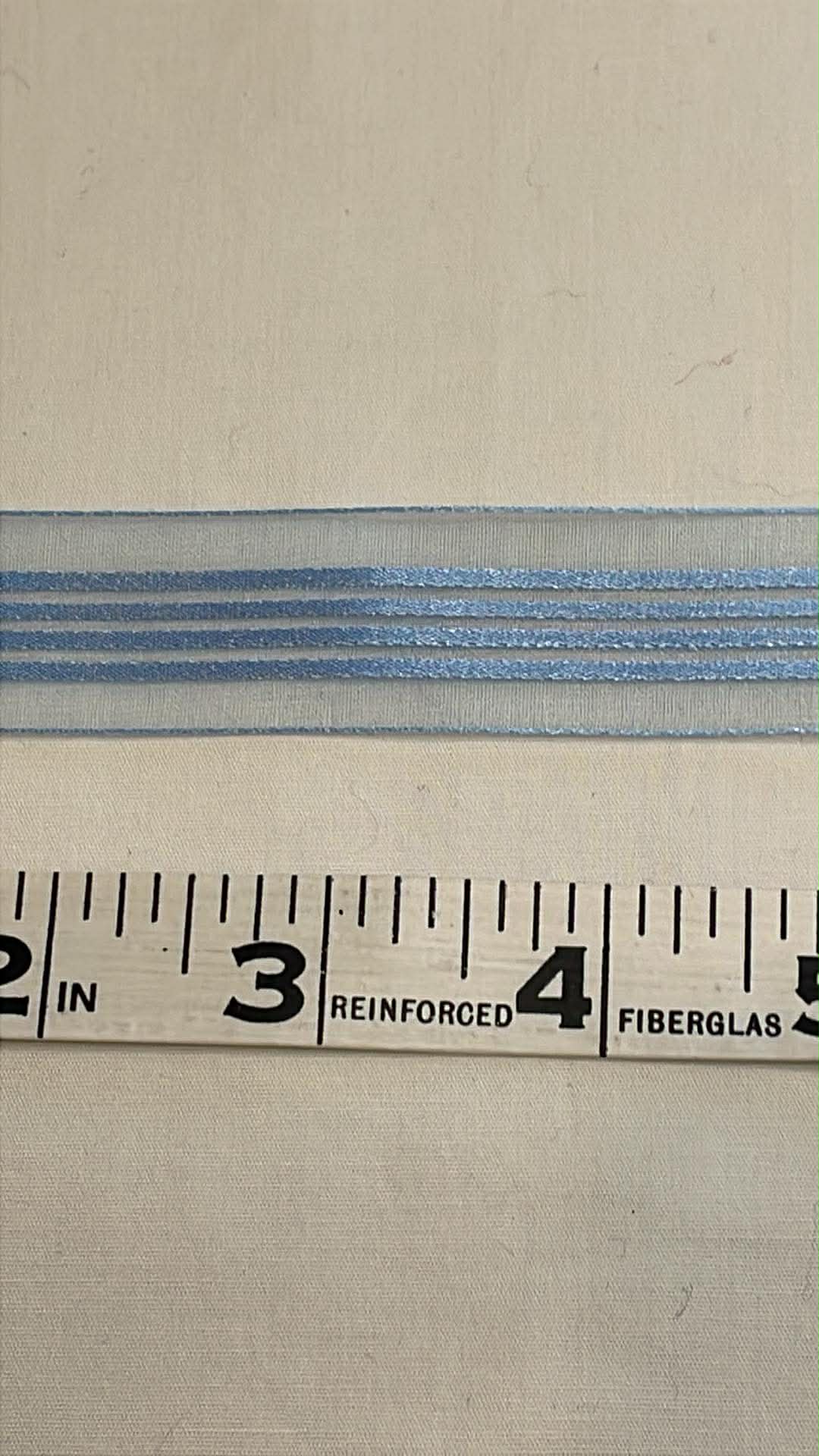 .875" wide blue striped sheer ribbon sold by the yard.