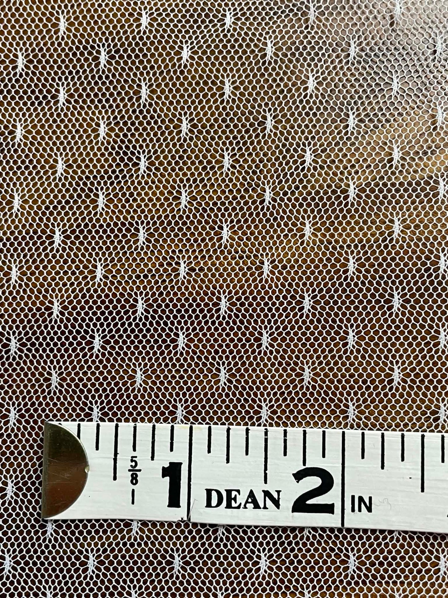 White mesh with pattern white specks.  Sold by the yard.