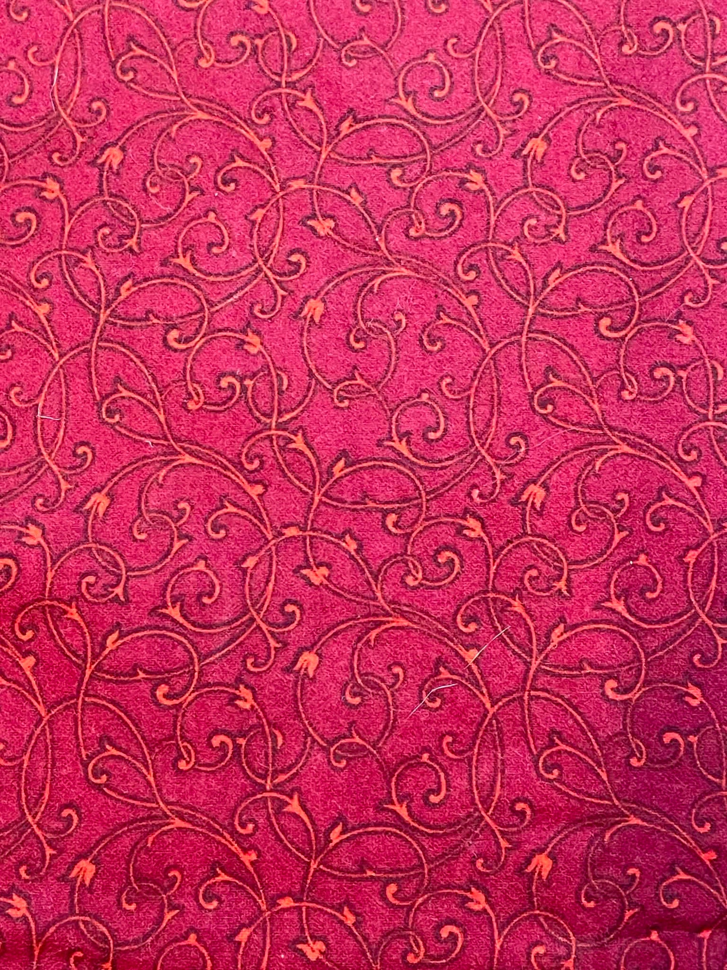 Flannel.  Deep red with swirls.  Sold by the yard.