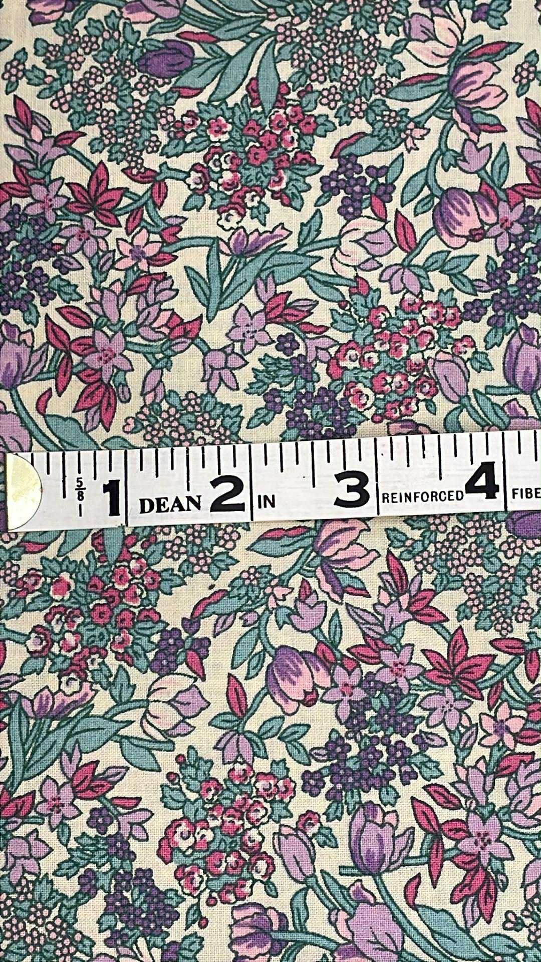 Pink and purple flowers with green leaves on beige background