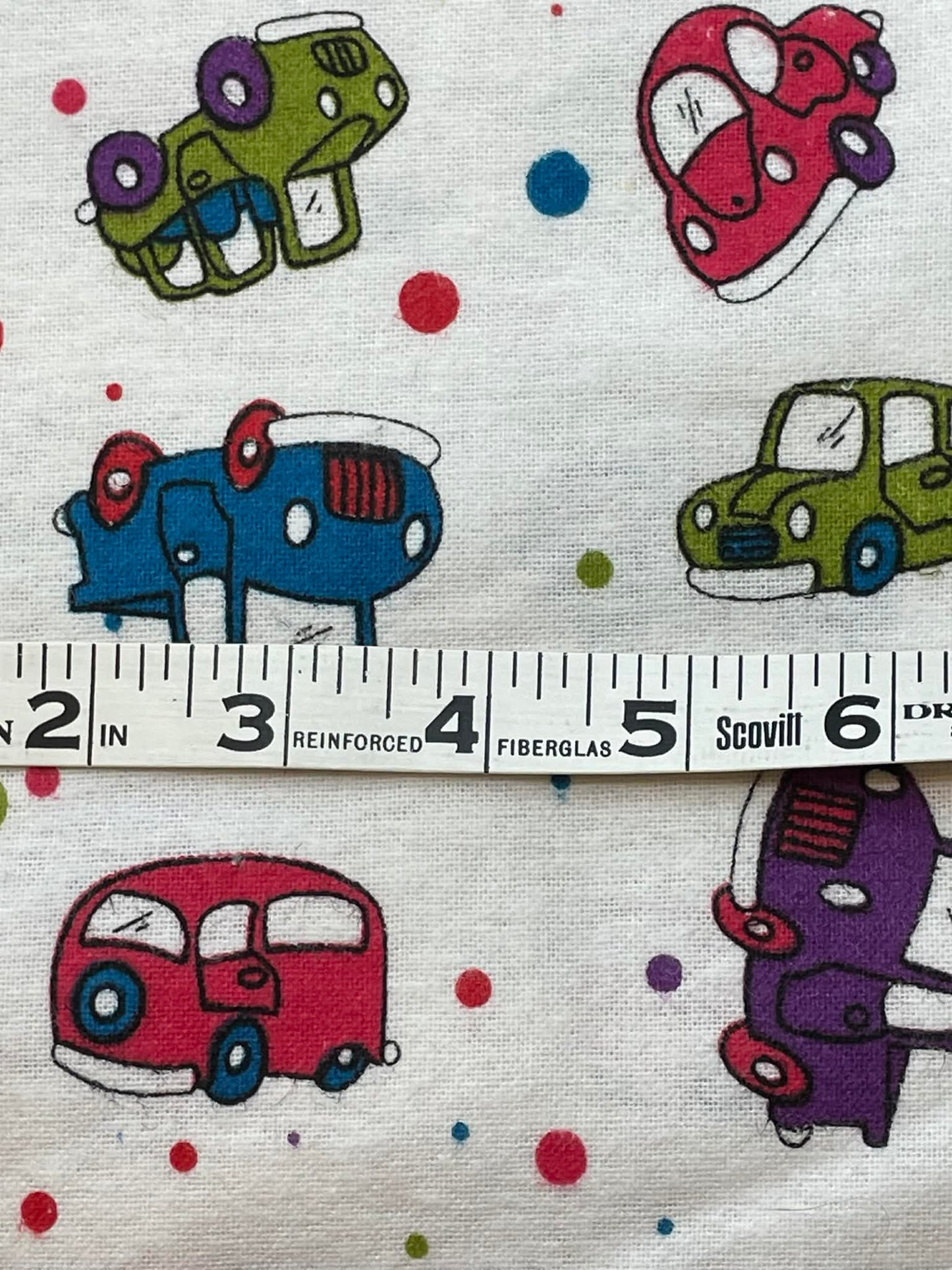 Flannel cartoon cars and polka dots.  Sold by the yard.