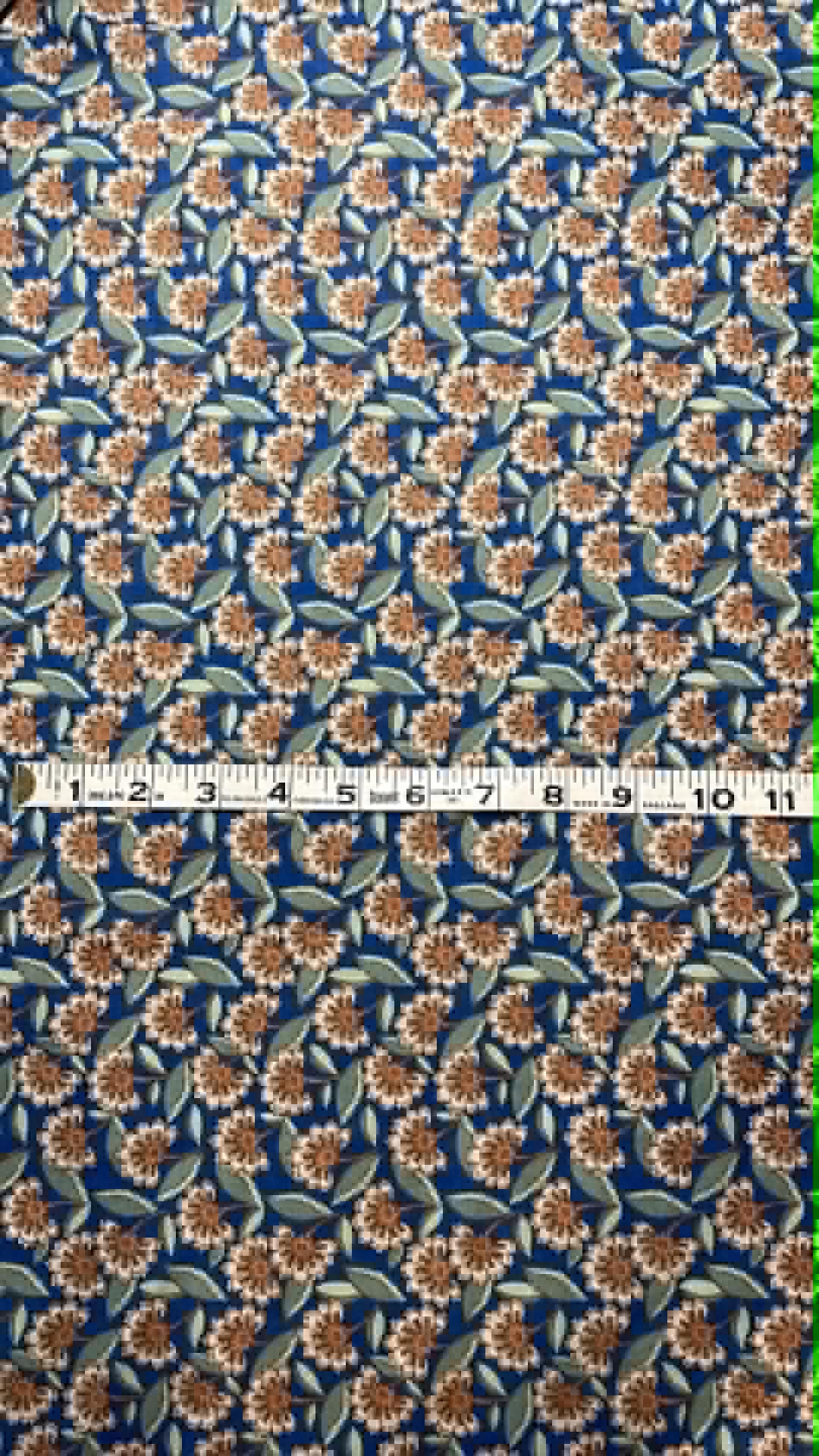 Beige and brown flowers on blue background.  Crepe.