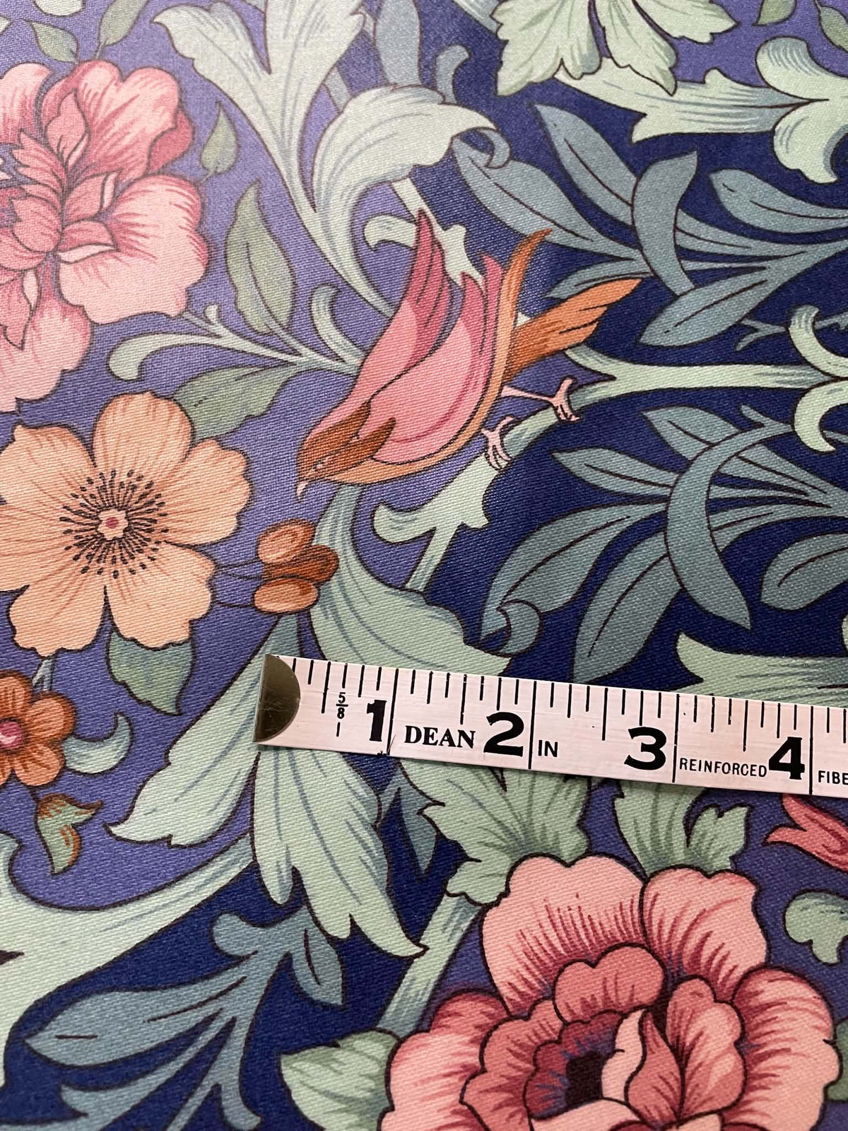 Interior upholstery fabric.  Peach and pink floral with a nice sheen.  Sold by the yard.