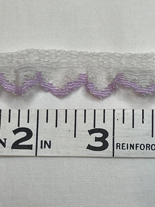 1/5" wide.  White and lavender lace trim.  Sold by the yard.