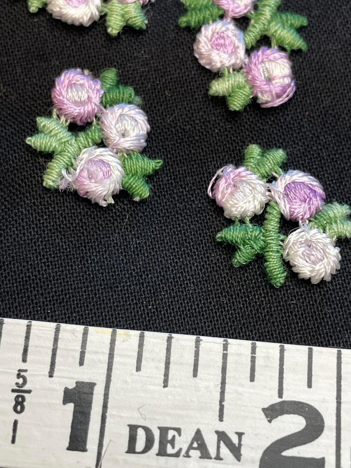 13 tiny embroidered flowers applique sold as a group.