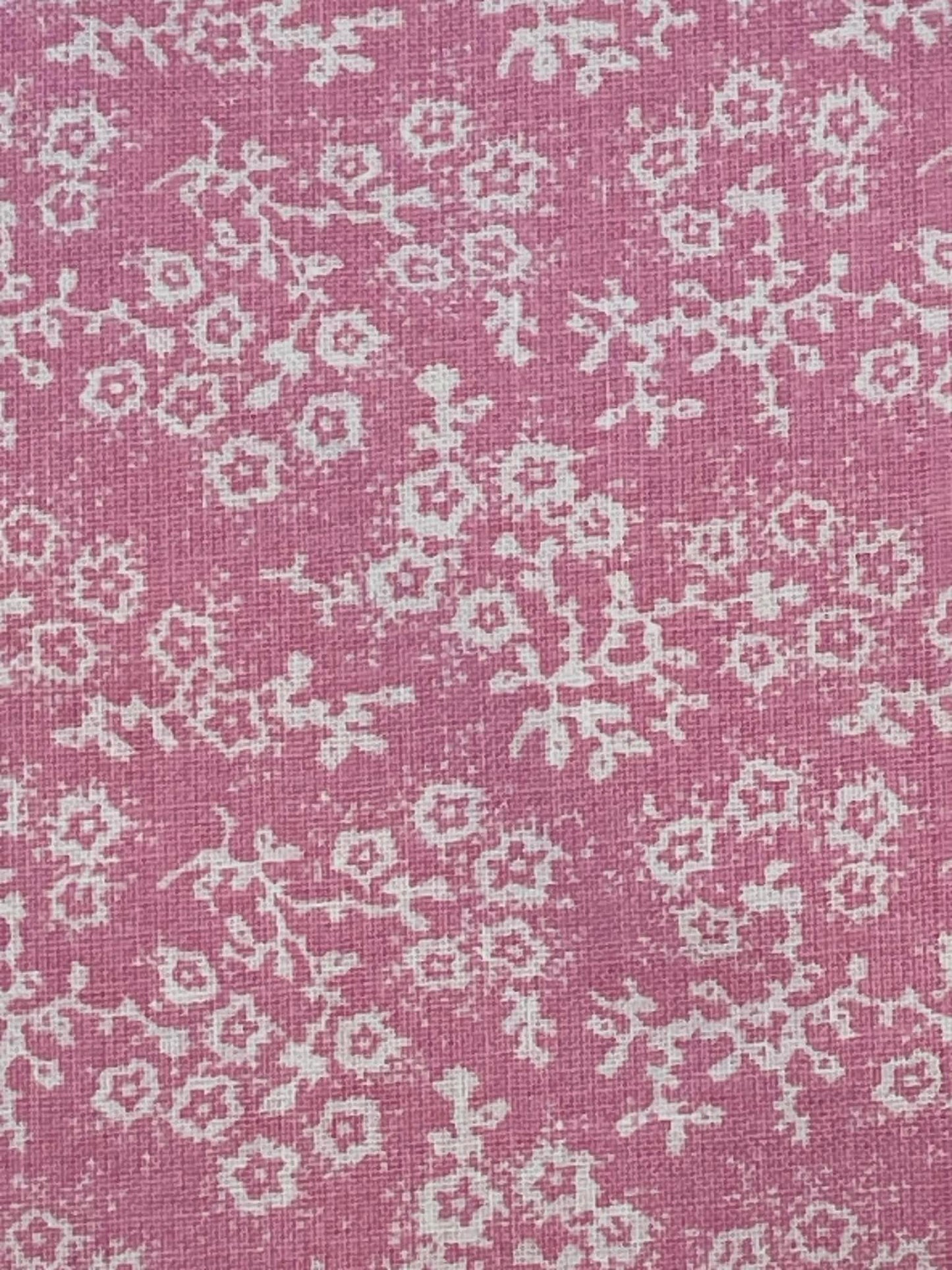 White floral calico on pink background.  Sold by the yard.