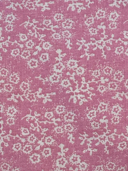 White floral calico on pink background.  Sold by the yard.