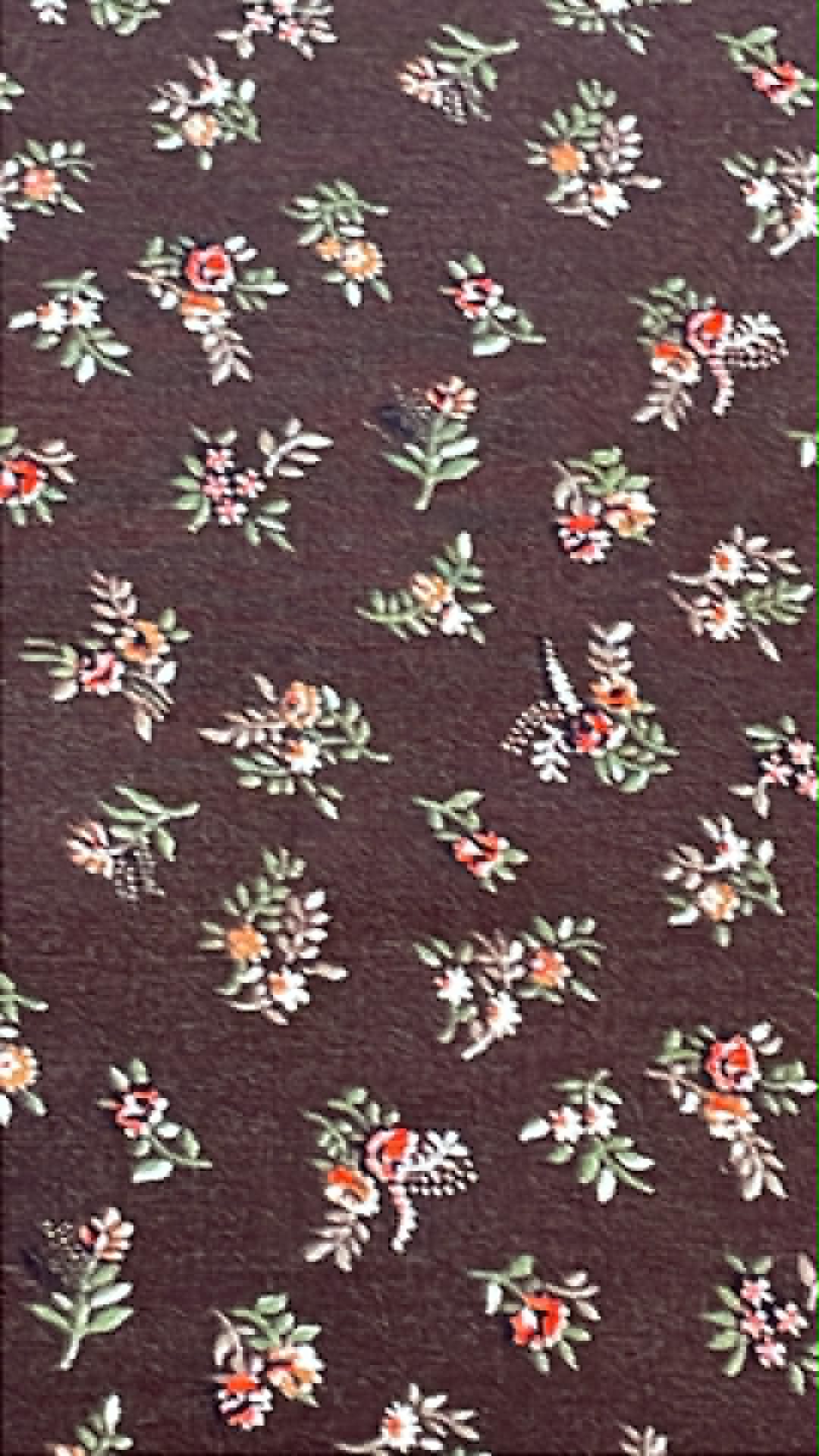 Vintage floral on dark brown background.  Sold by the half yard.