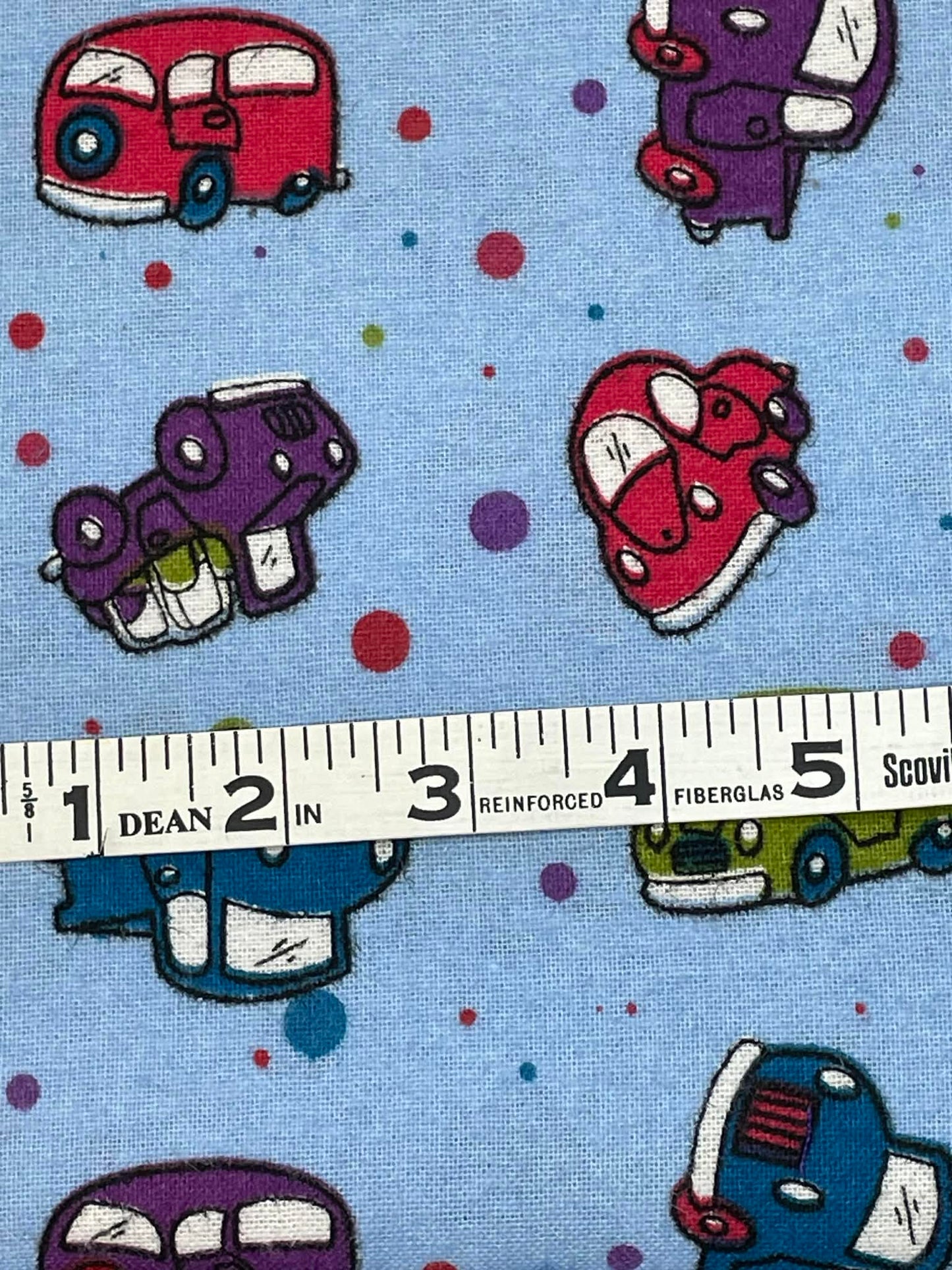 Flannel cartoon cars and polka dots.  Sold by the yard.