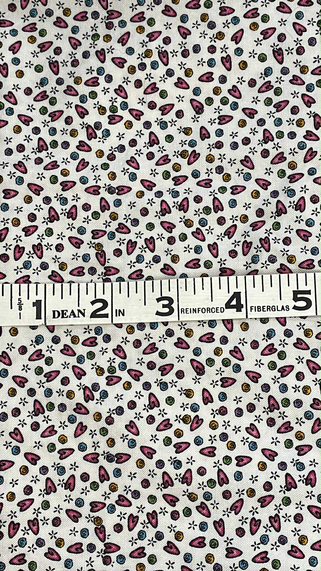 Elongated pink hearts and different colored swirls on white background