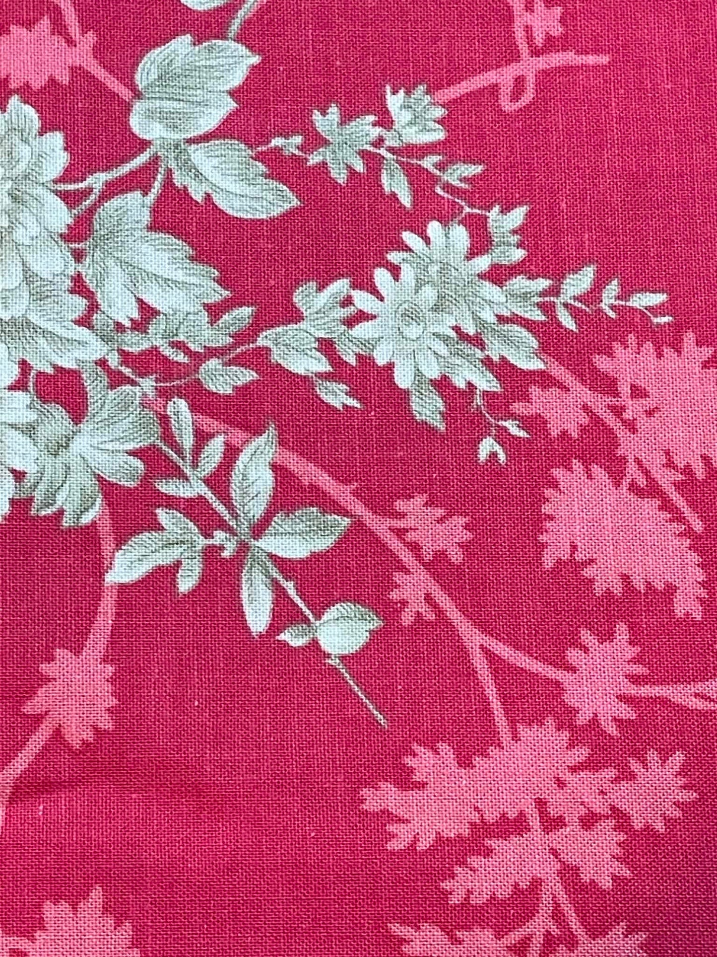 Notting Hill.  Tan floral on muted red background.  Sold by the yard.