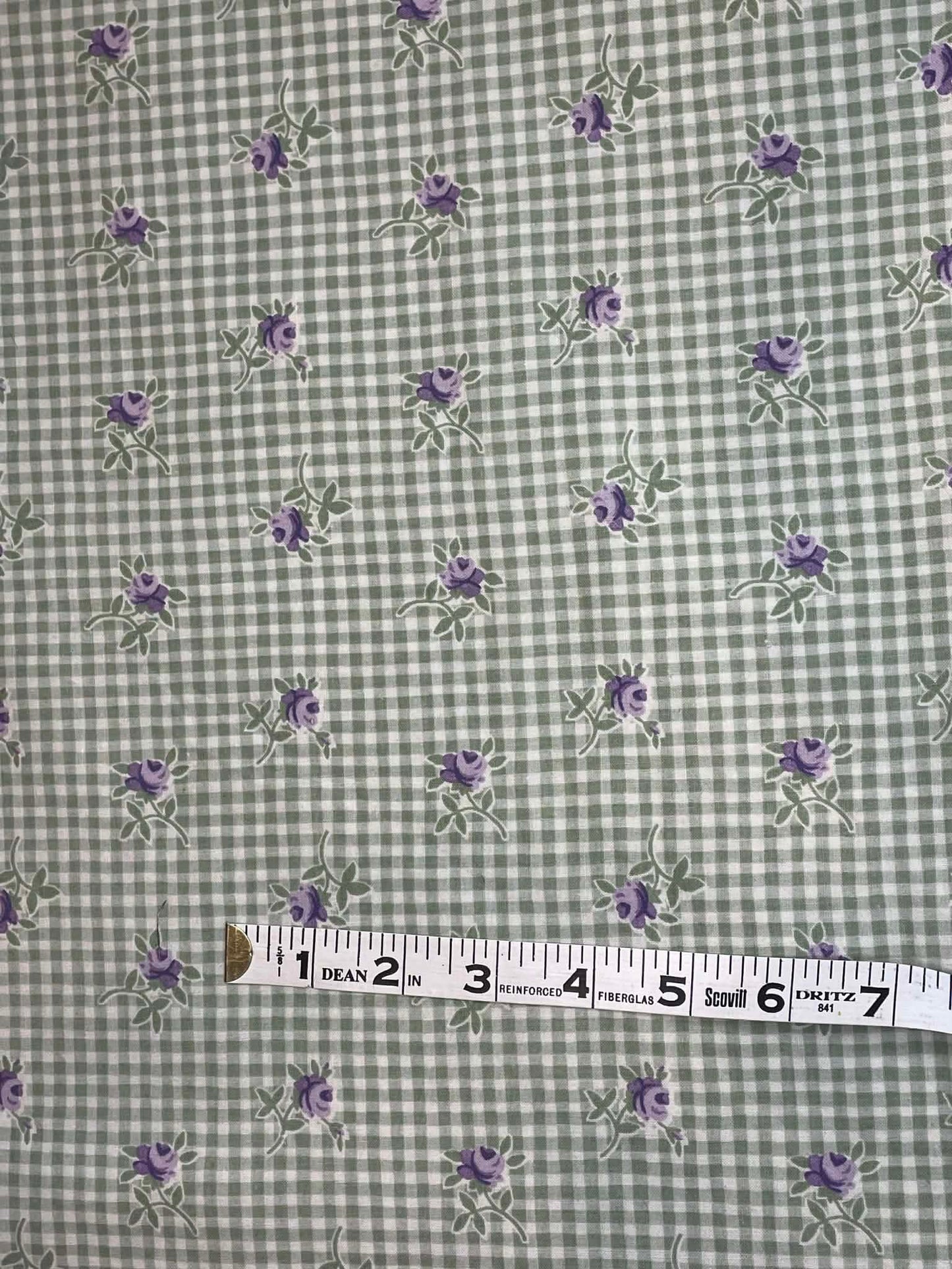 Purple flowers on green and white check background.  Sold by the half yard.