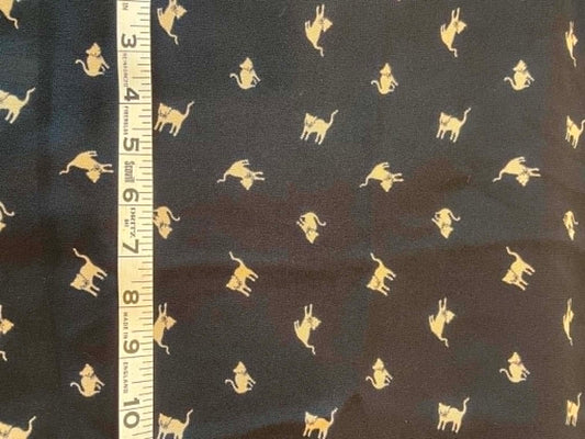 Crepe tan cats on black background.  Sold by the 1/2 yard.