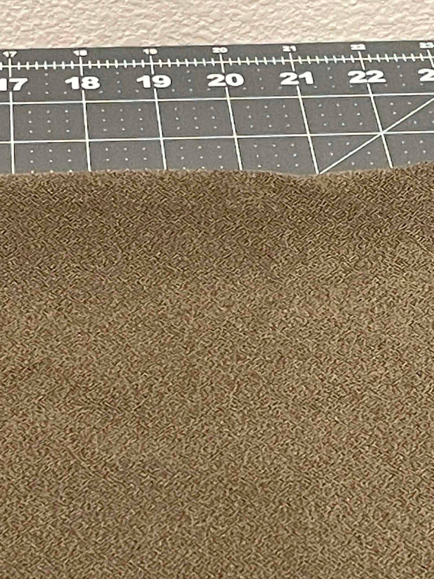 Greenish colored heavy apparel crepe fabric.  Sold by the yard.