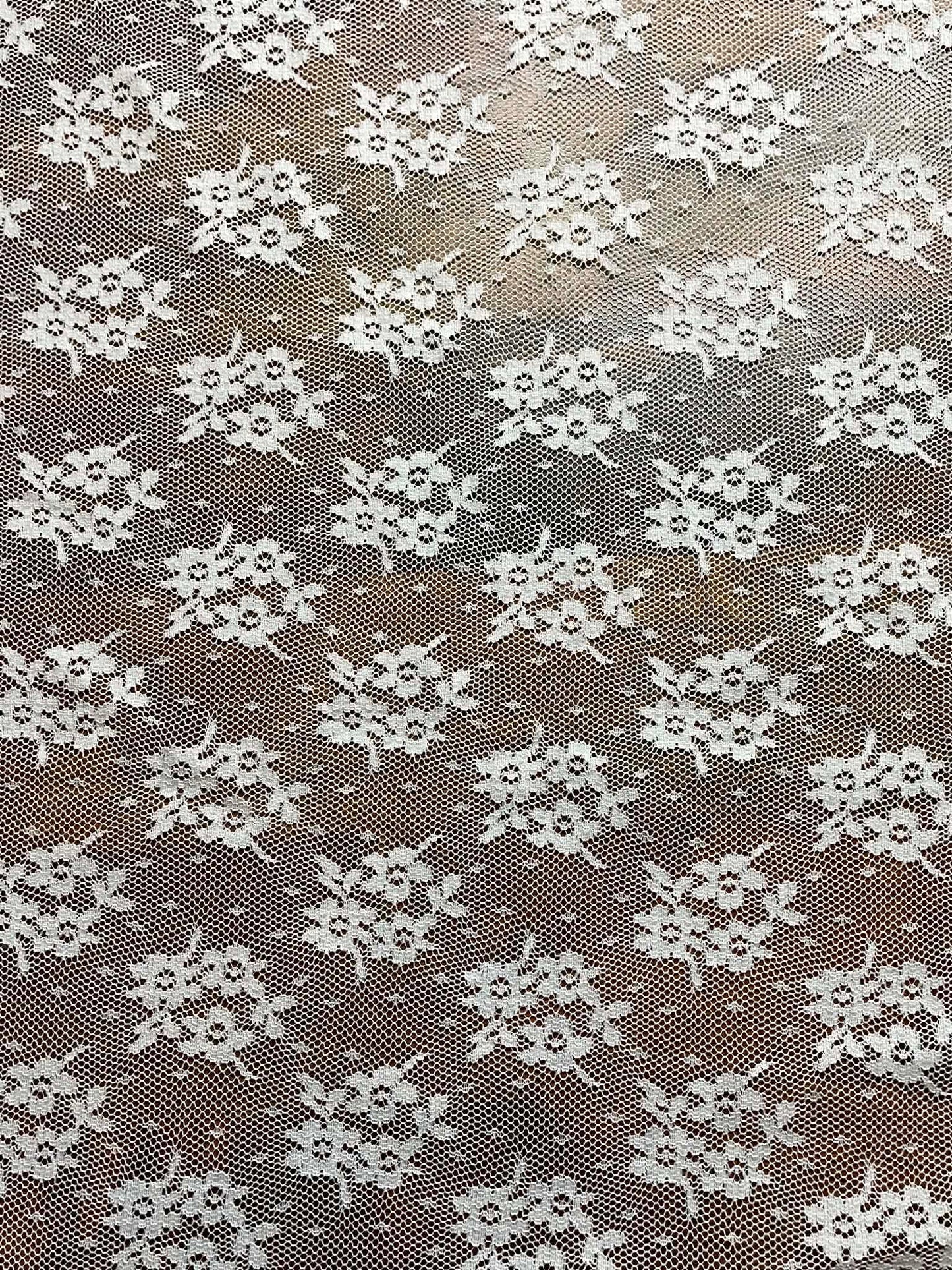 White floral all over lace.  Sold by the half yard.